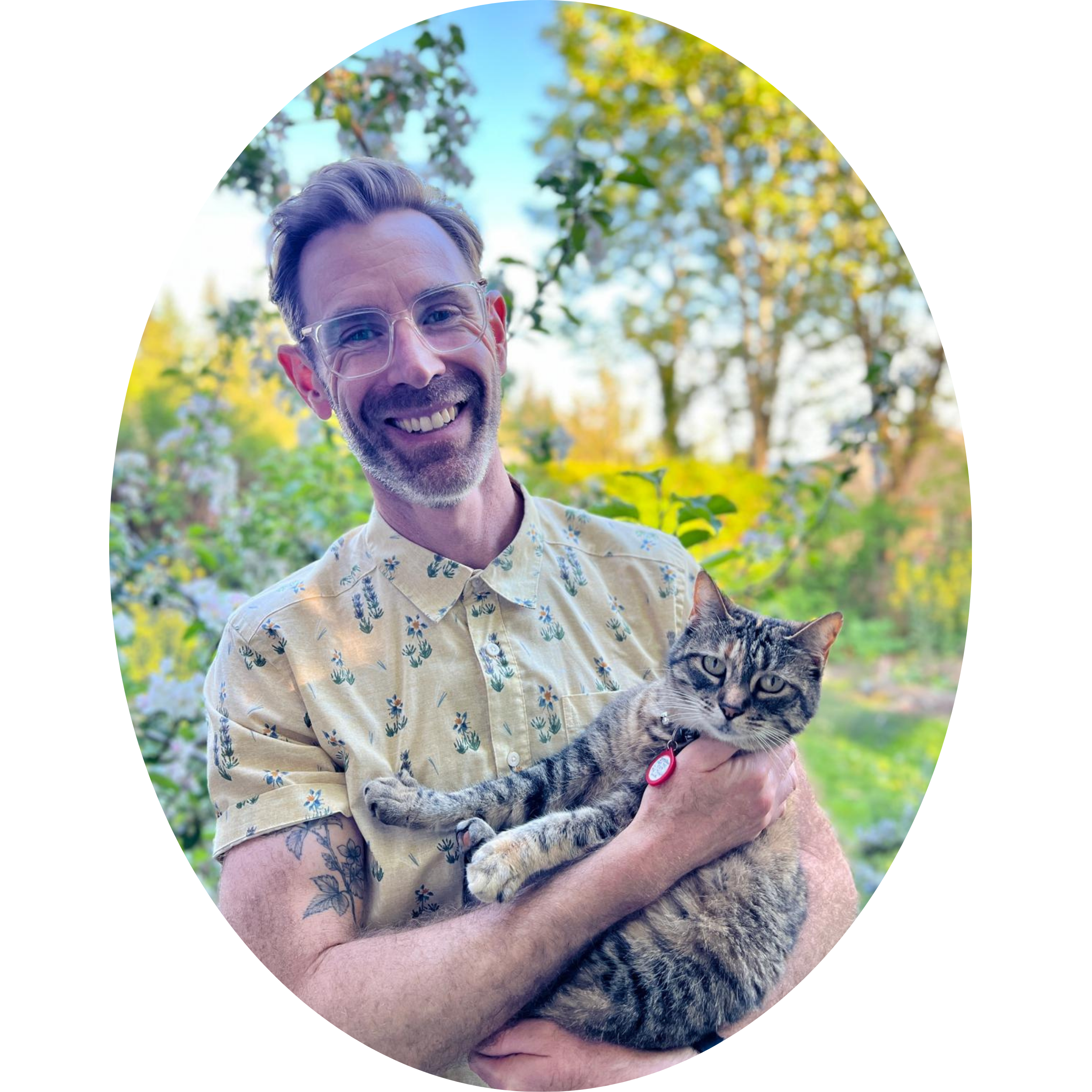 A man holding a cat and smiling