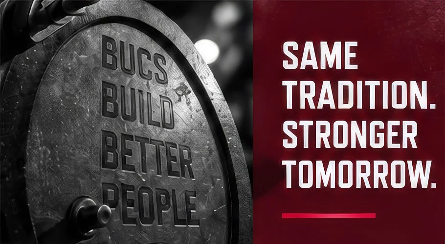 A weight that says Bucs Build Better People with a side panel that reads: Same tradition. Stronger tomorrow