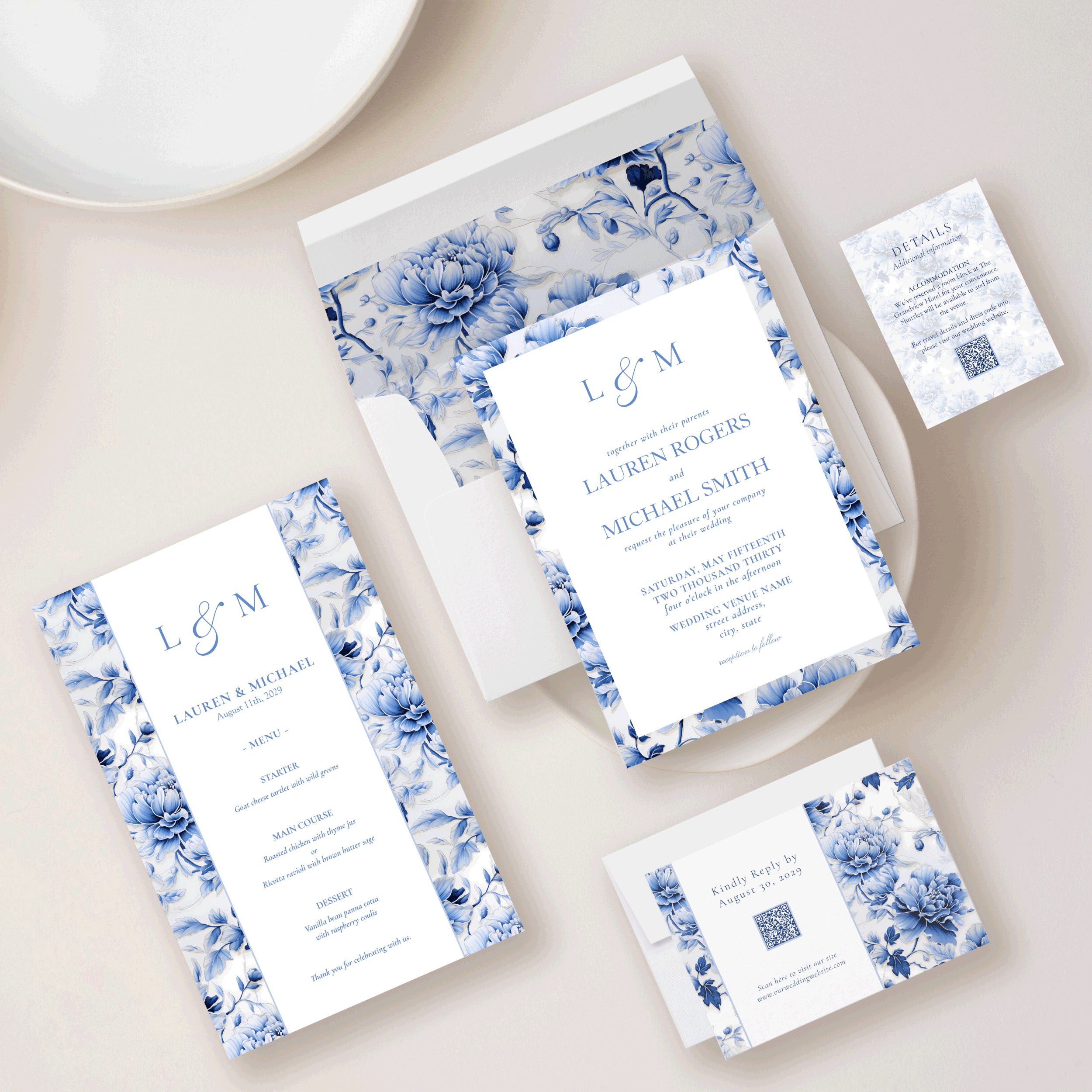 Flat lay of an Oriental Chinoiserie wedding invitation suite in blue and white, featuring floral patterns, coordinated menu, RSVP card, envelope liner, and details card, styled with neutral tableware.