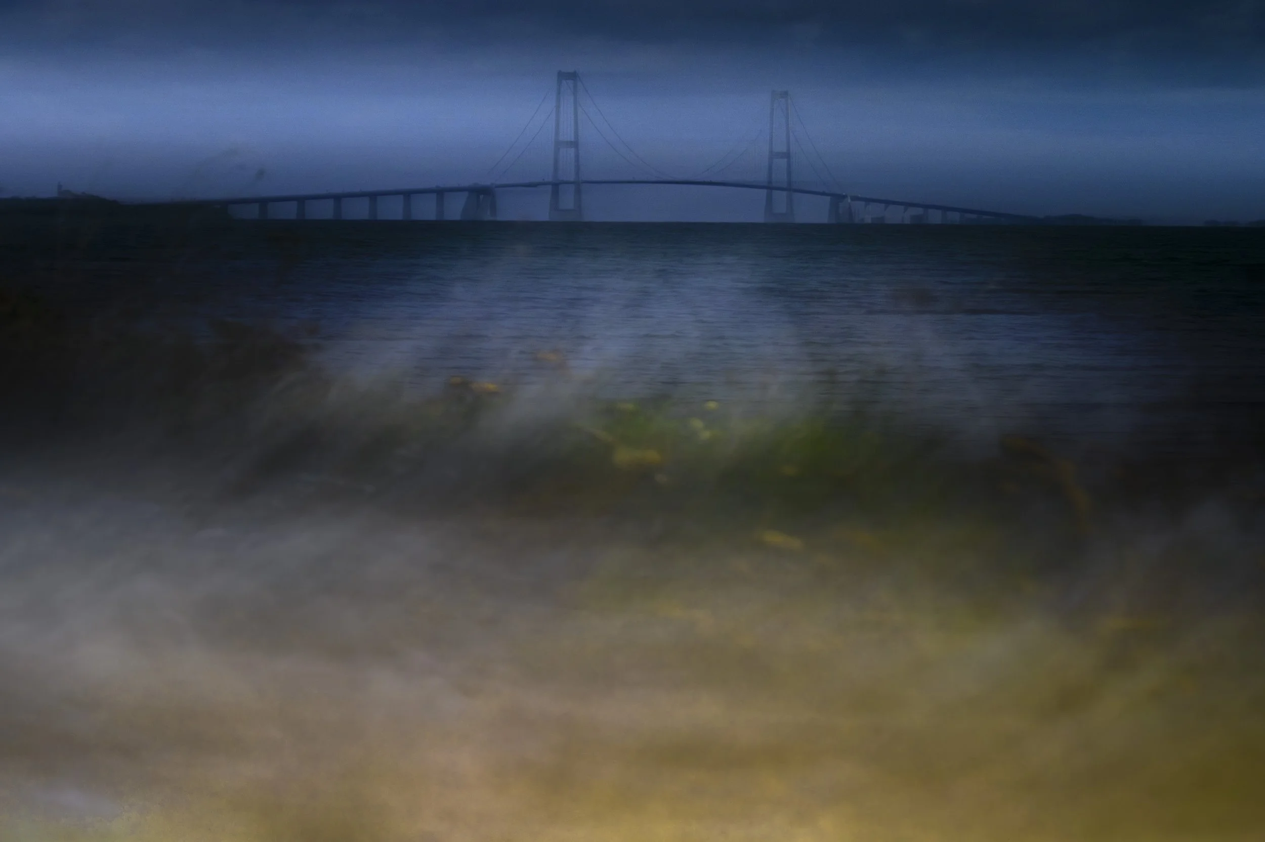 2025-08-23. To get to the Atlantic coast of western Denmark in Jutland, one has to cross two islands: Sjælland and Fyn, each connected by its own bridges. The bridge of Store Belt is very long and a beautiful hanging bridge. Here shot in ICM techniqu