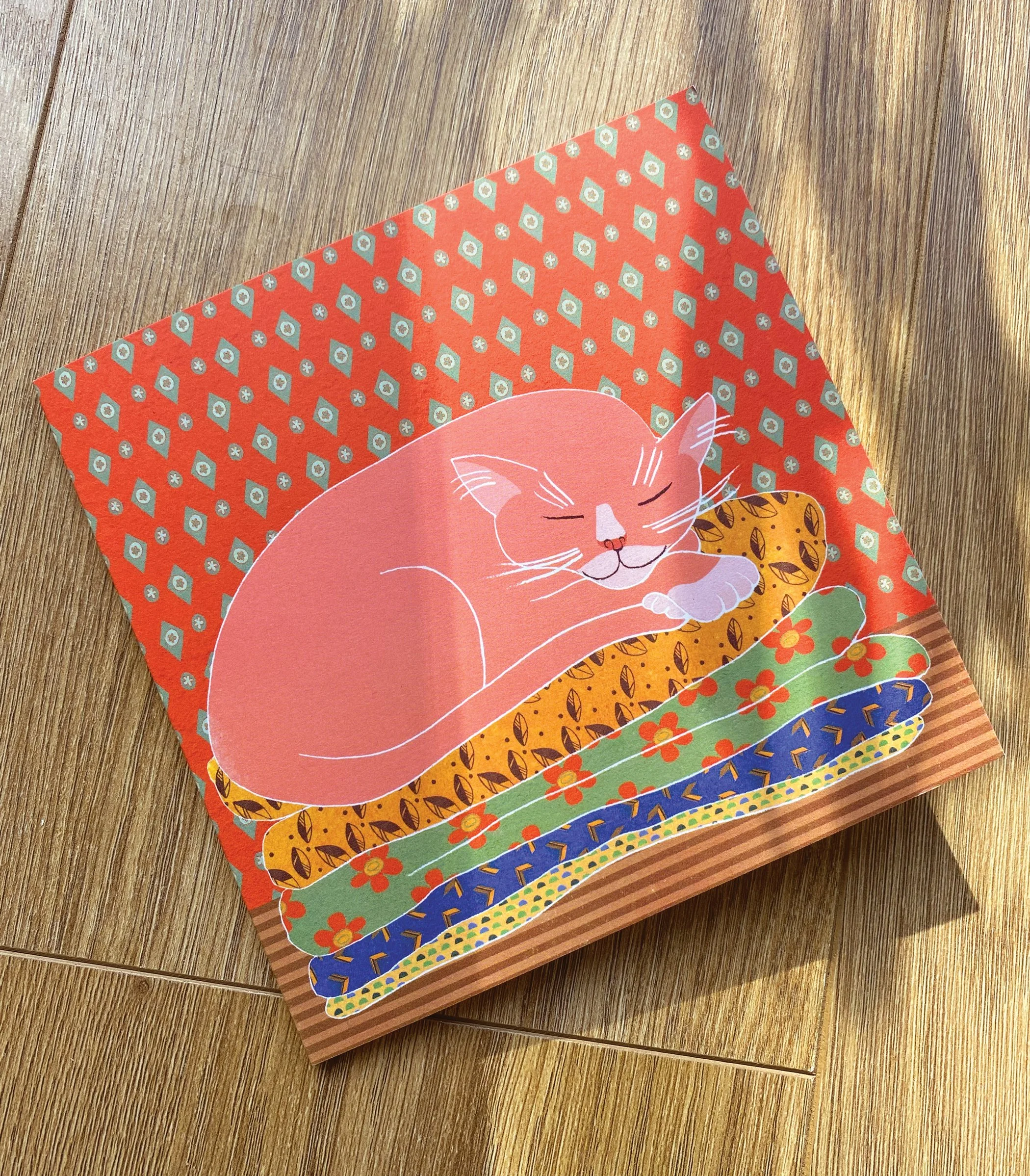 pink-cat-in-hand-on-wood-LOW.jpg