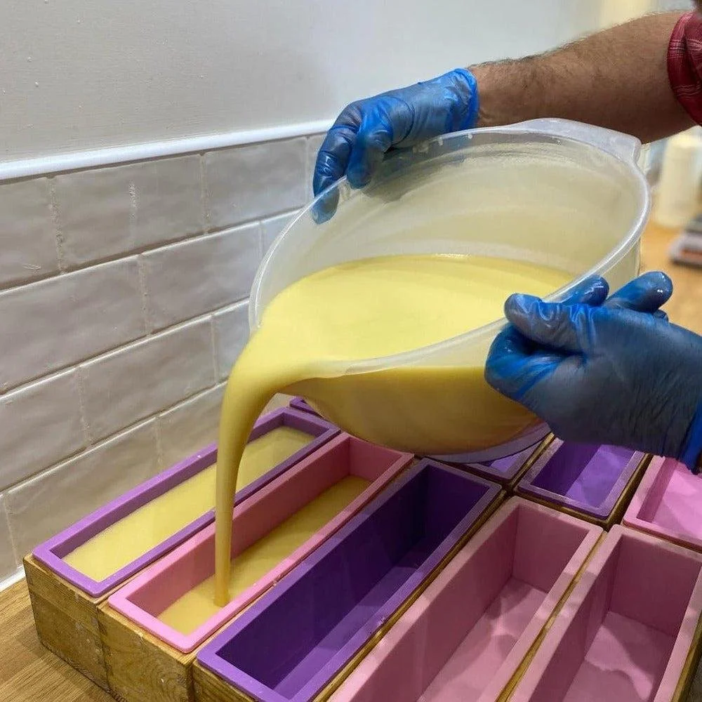 Pouring some roar cold process soap batter into the molds to cure for 4 weeks