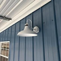 Exterior wall of a building with a white outdoor wall-mounted lamp.