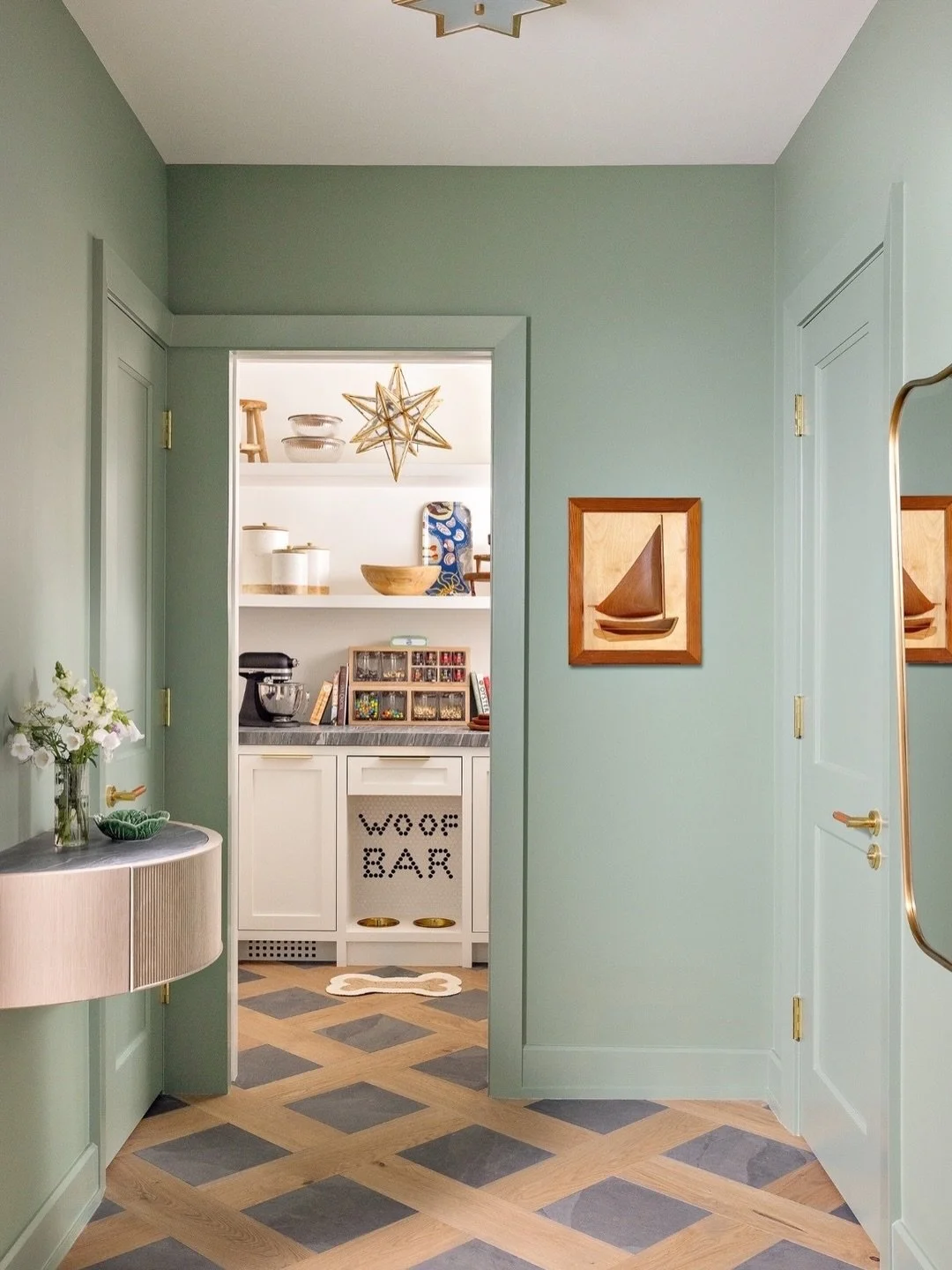 The pantry and woof bar for the doggy of the house is hidden away by a beautiful oak pocket door. Ideal for drying muddy paws and keeping things out of the kitchen which don&rsquo;t get used every day. The beautiful green colour washed hallway is pai