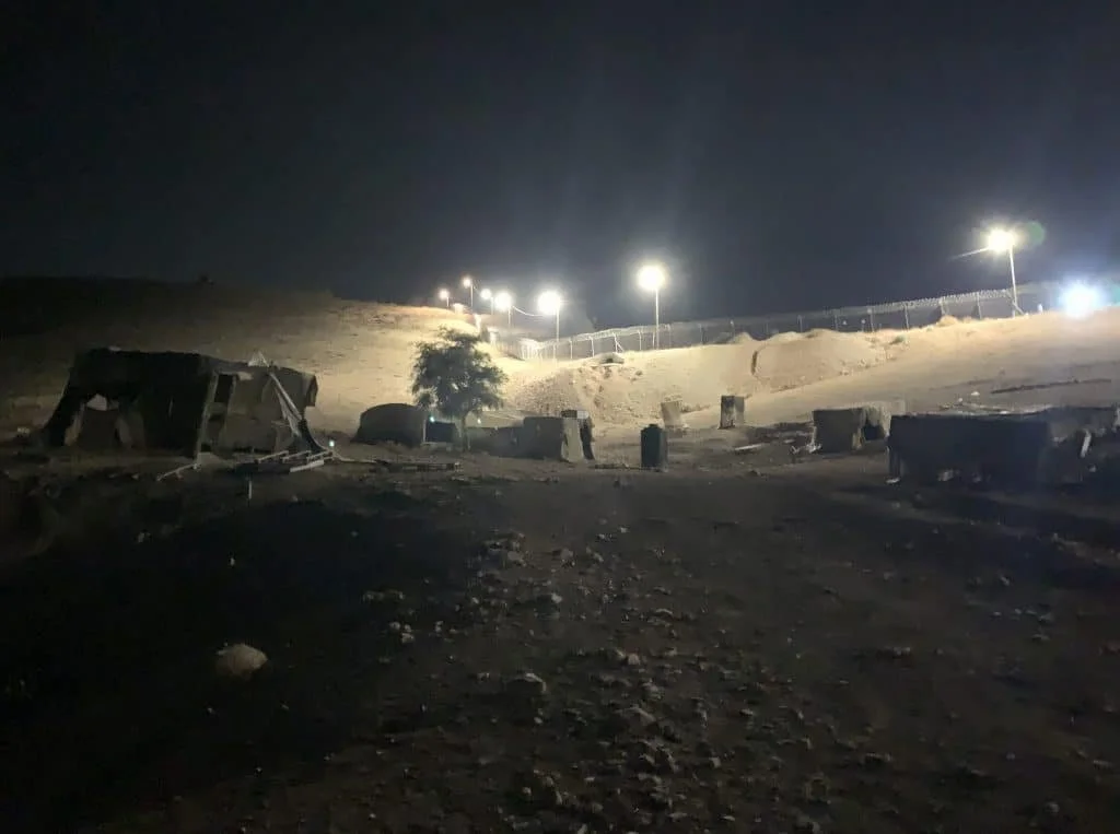 Bright floodlights beaming from an Israeli towards a Palestinian village on October 31, 2025. PHOTO: Giancarlo Cininni