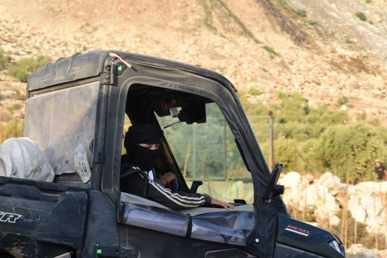 Two young Israeli settlers ride in an atv along the dirt roads of Palestinian village Al Mugyhahir on November 24, 2025. The settlers are an almost daily presence. PHOTO: Giancarlo Cininni