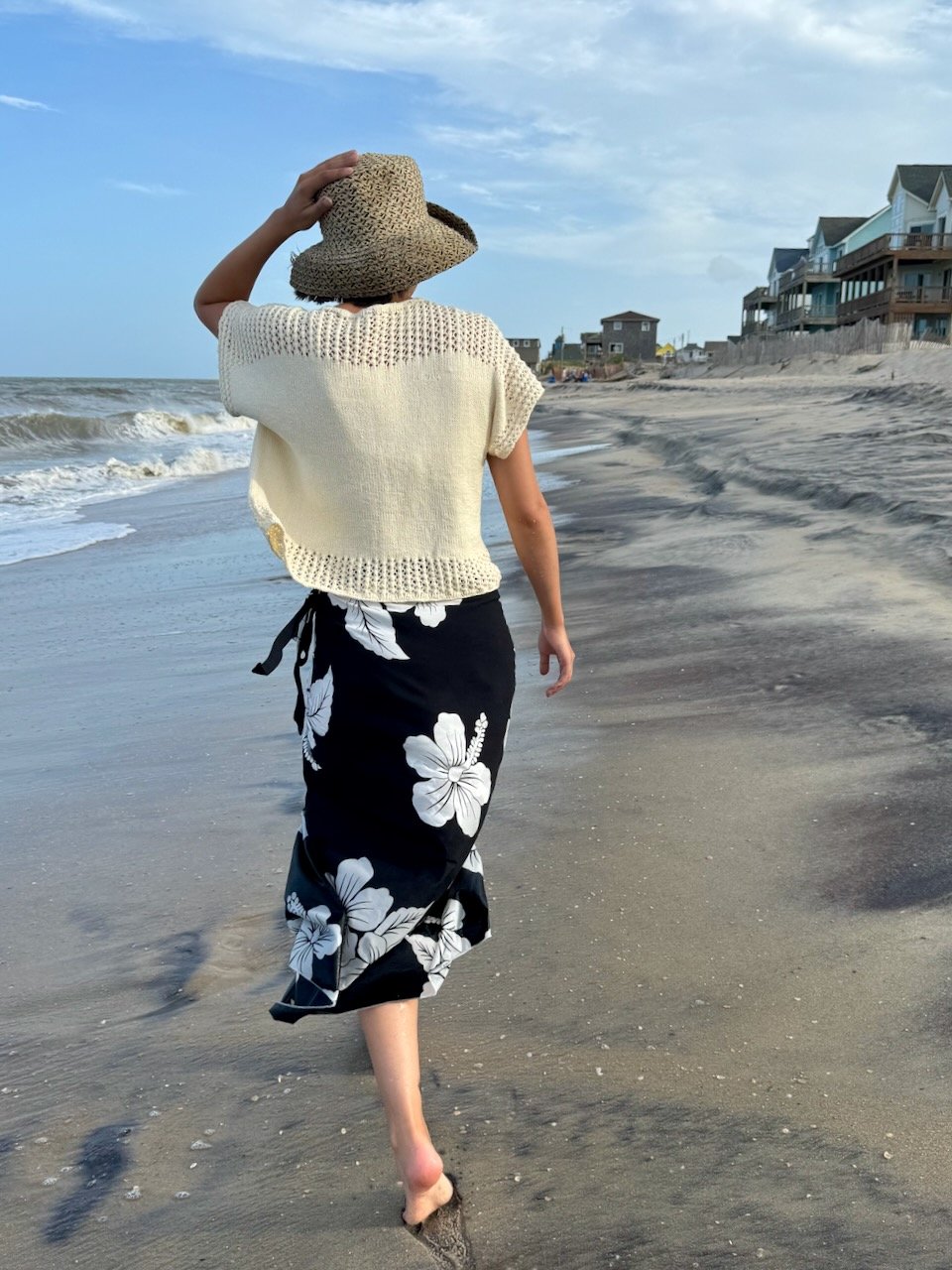 Chic summer knit top with a breezy lace yoke and delicate lace trim, perfect for effortless beach fashion. This lightweight, short-sleeved sweater drapes beautifully for a relaxed yet elegant look.