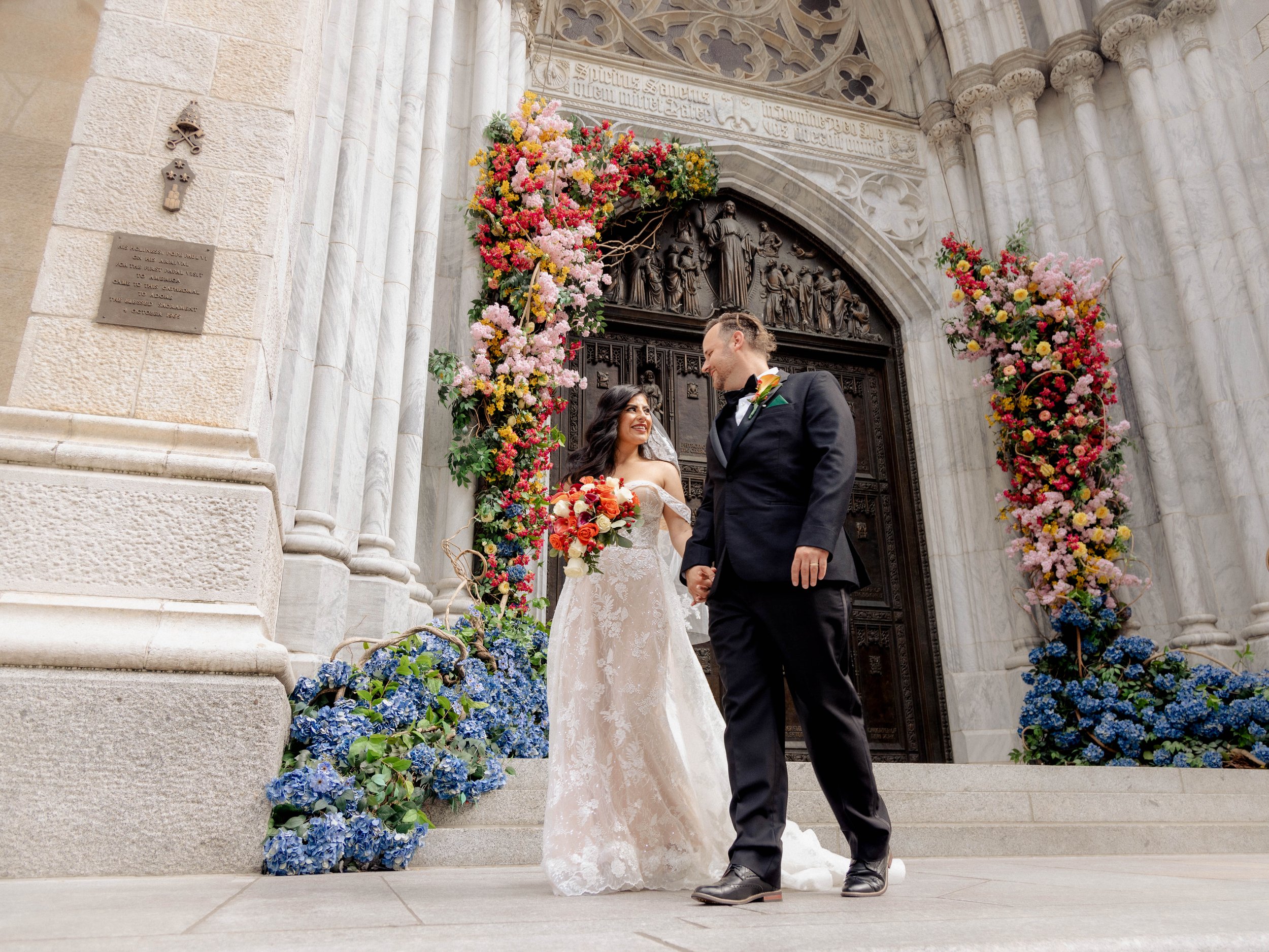 Radiant newlyweds outside St. Patrick's Cathedral after the wedding ceremony, capturing a magical moment of celebration and love.