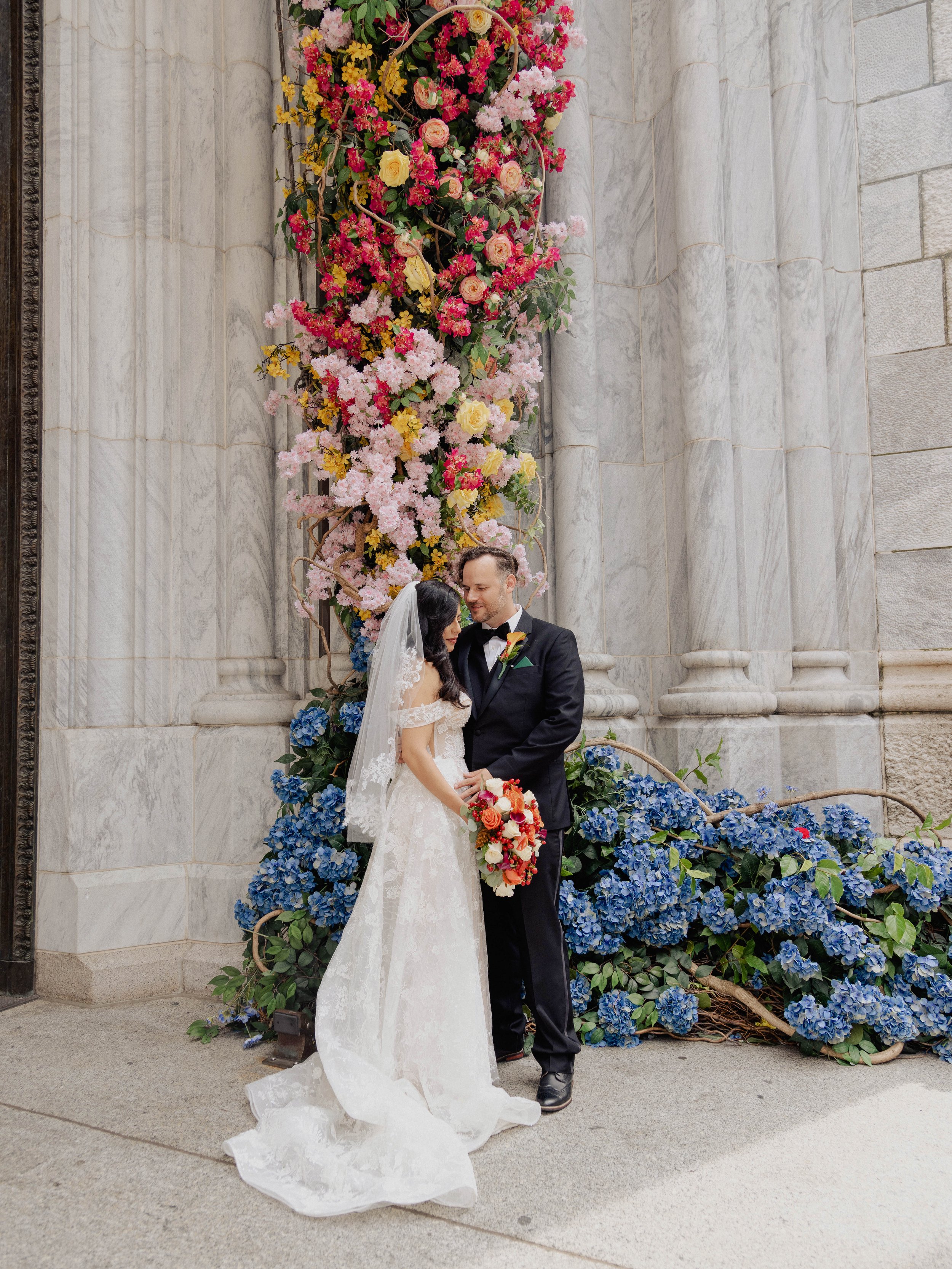 Radiant newlyweds outside St. Patrick's Cathedral after the wedding ceremony, capturing a magical moment of celebration and love.