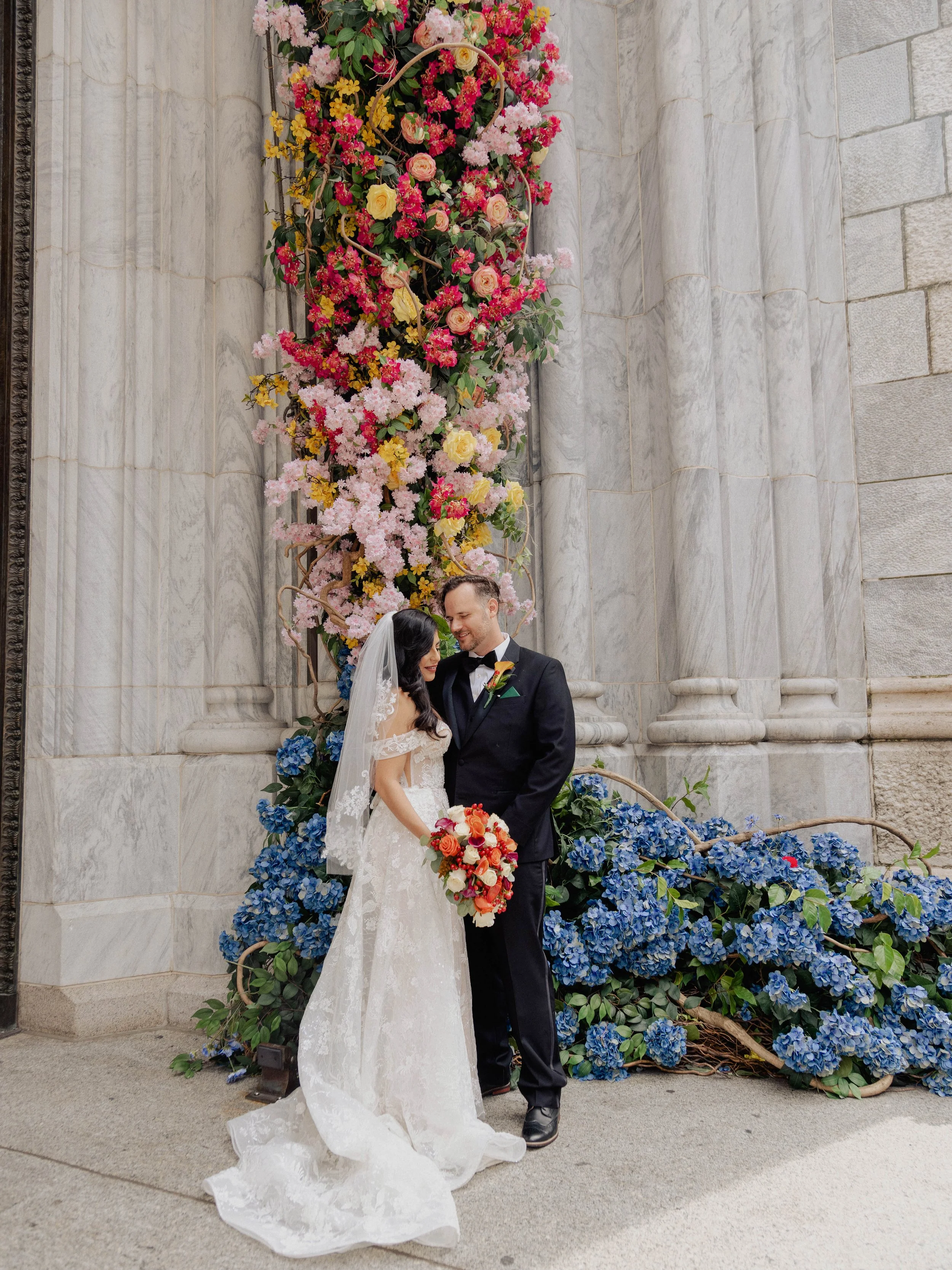 Radiant newlyweds outside St. Patrick's Cathedral after the wedding ceremony, capturing a magical moment of celebration and love.