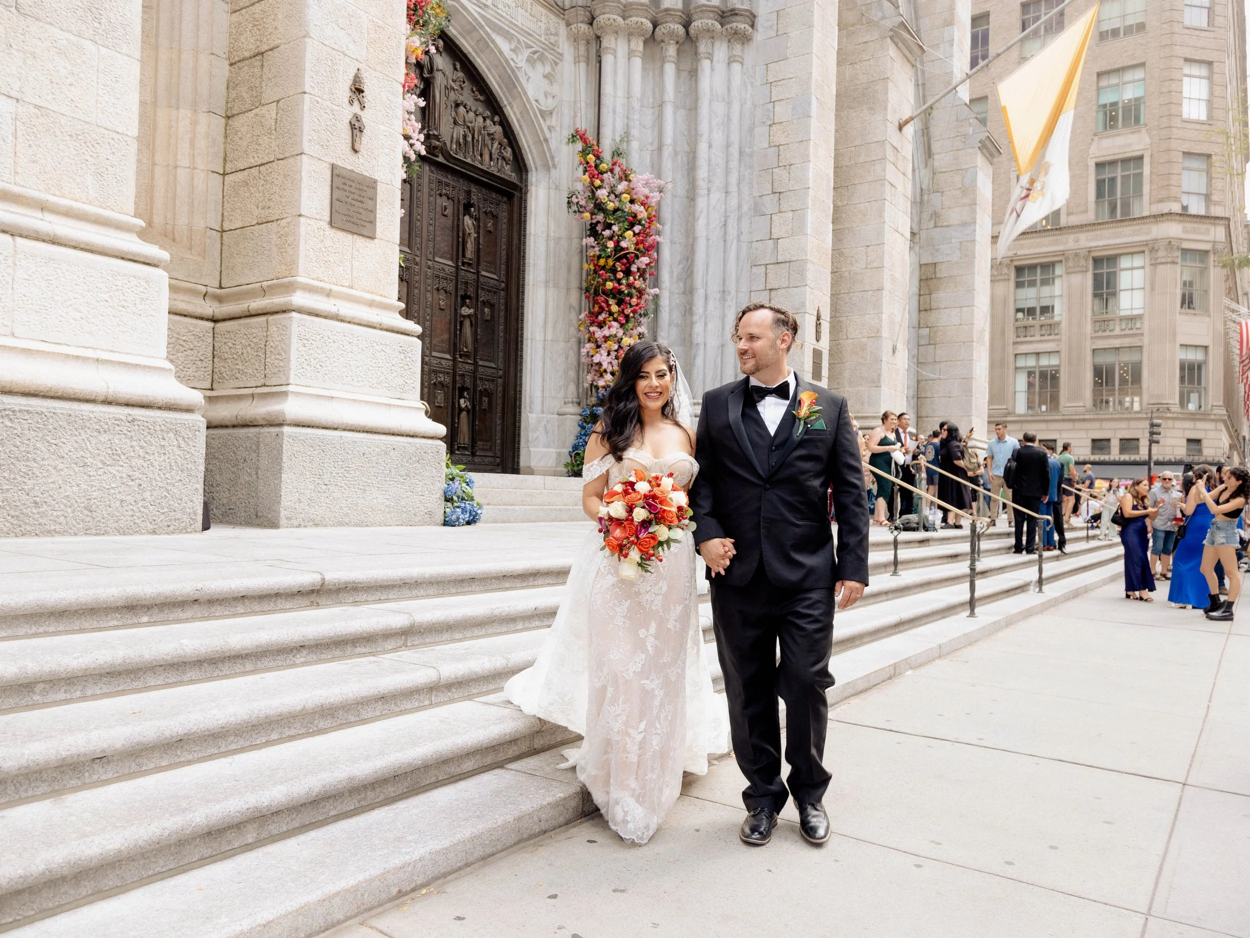 Radiant newlyweds outside St. Patrick's Cathedral after the wedding ceremony, capturing a magical moment of celebration and love.