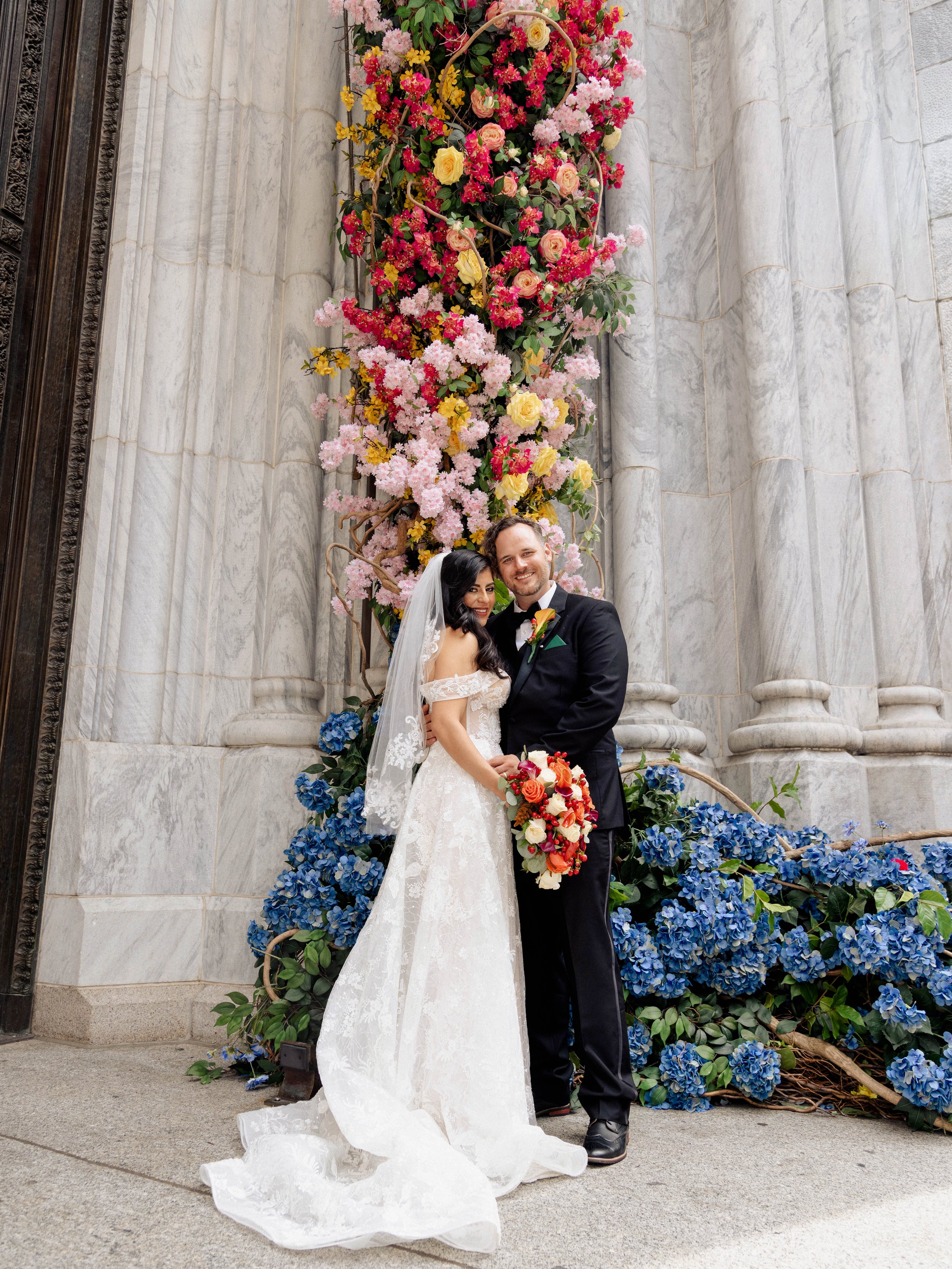 Radiant newlyweds outside St. Patrick's Cathedral after the wedding ceremony, capturing a magical moment of celebration and love.