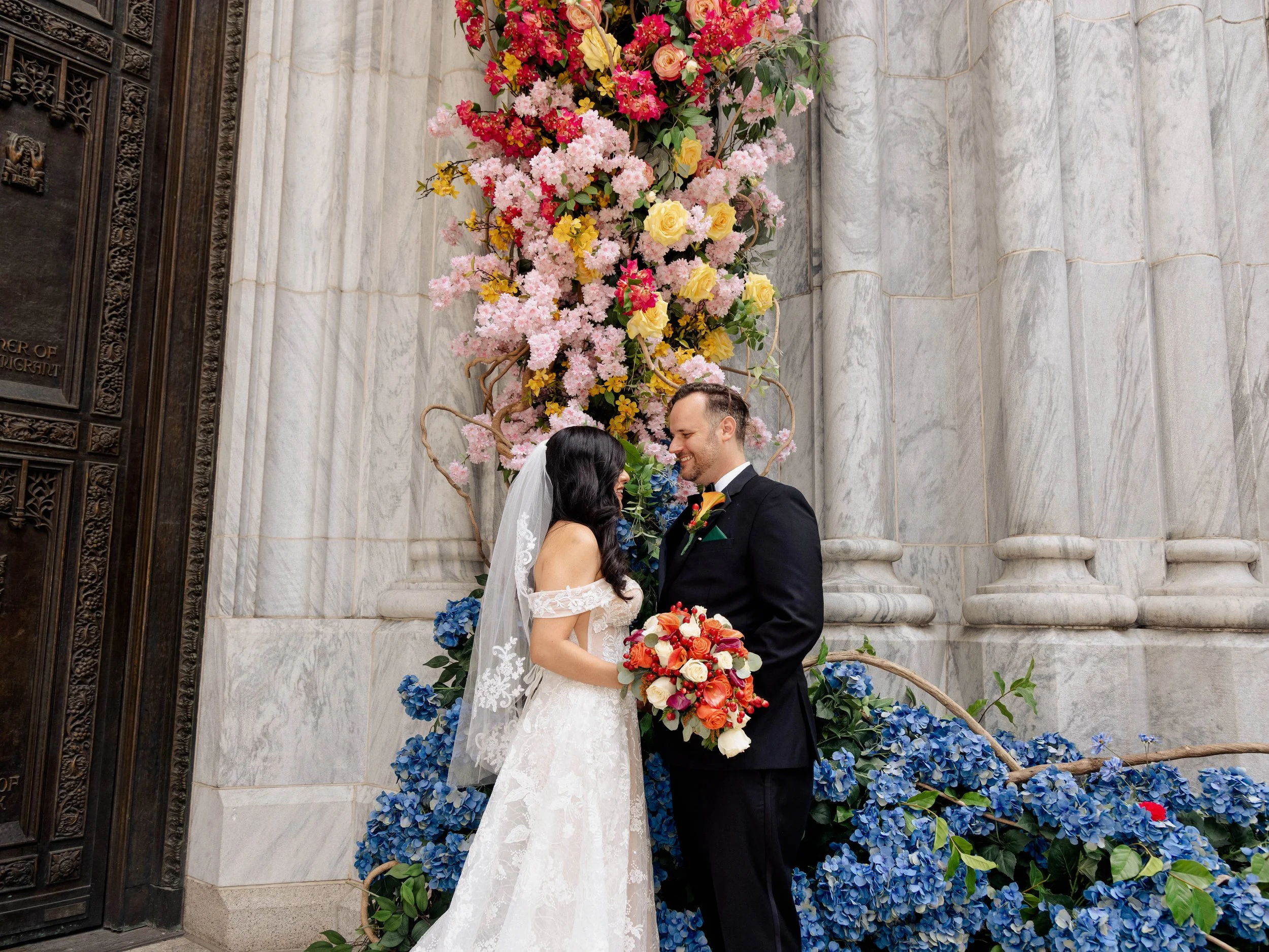 Radiant newlyweds outside St. Patrick's Cathedral after the wedding ceremony, capturing a magical moment of celebration and love.