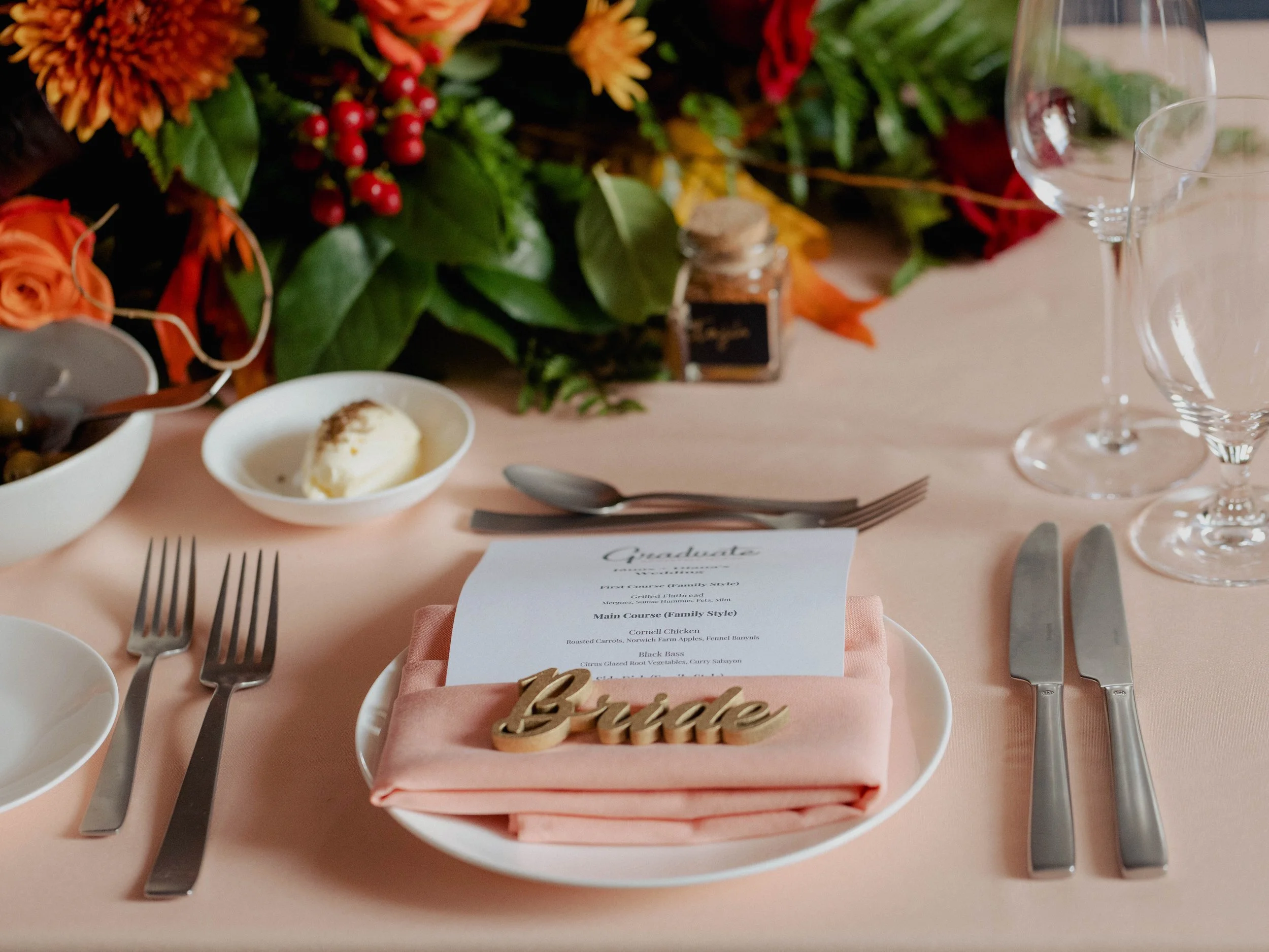 Beautiful decorations on the wedding reception tables, including pretty centerpieces, fancy tablecloths, and lovely flowers