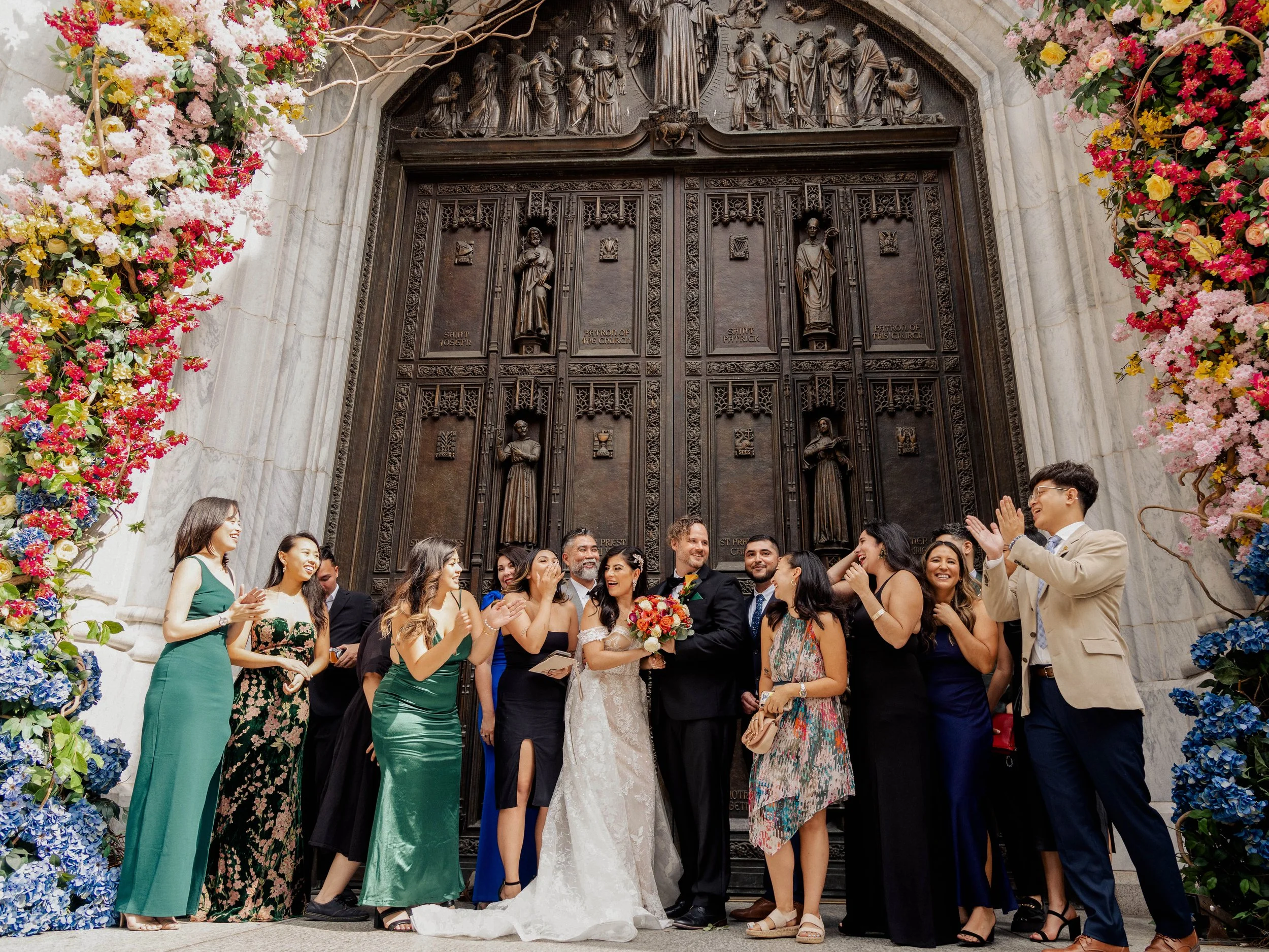 Radiant newlyweds and joyful guests gather outside St. Patrick's Cathedral, capturing a magical moment of celebration and love.