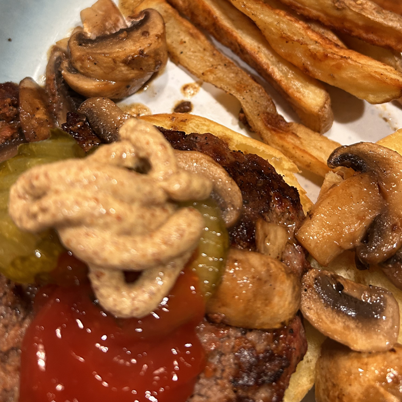 hamburger with mushrooms and fries, mustard