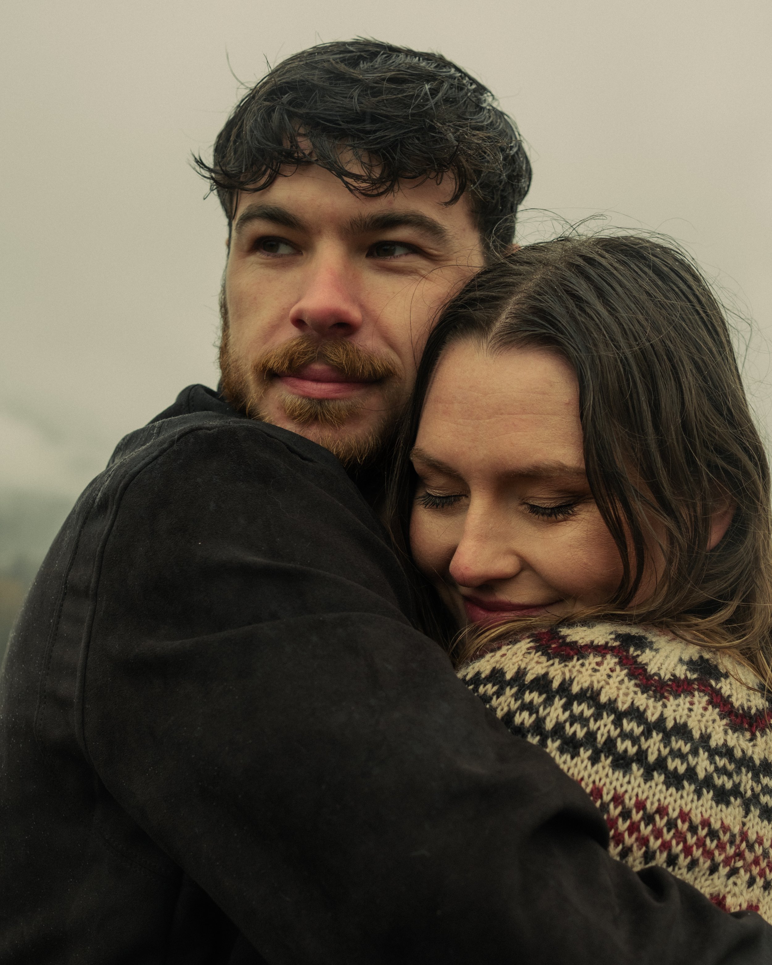 Couple embracing closely, intimate portrait with soft natural tones