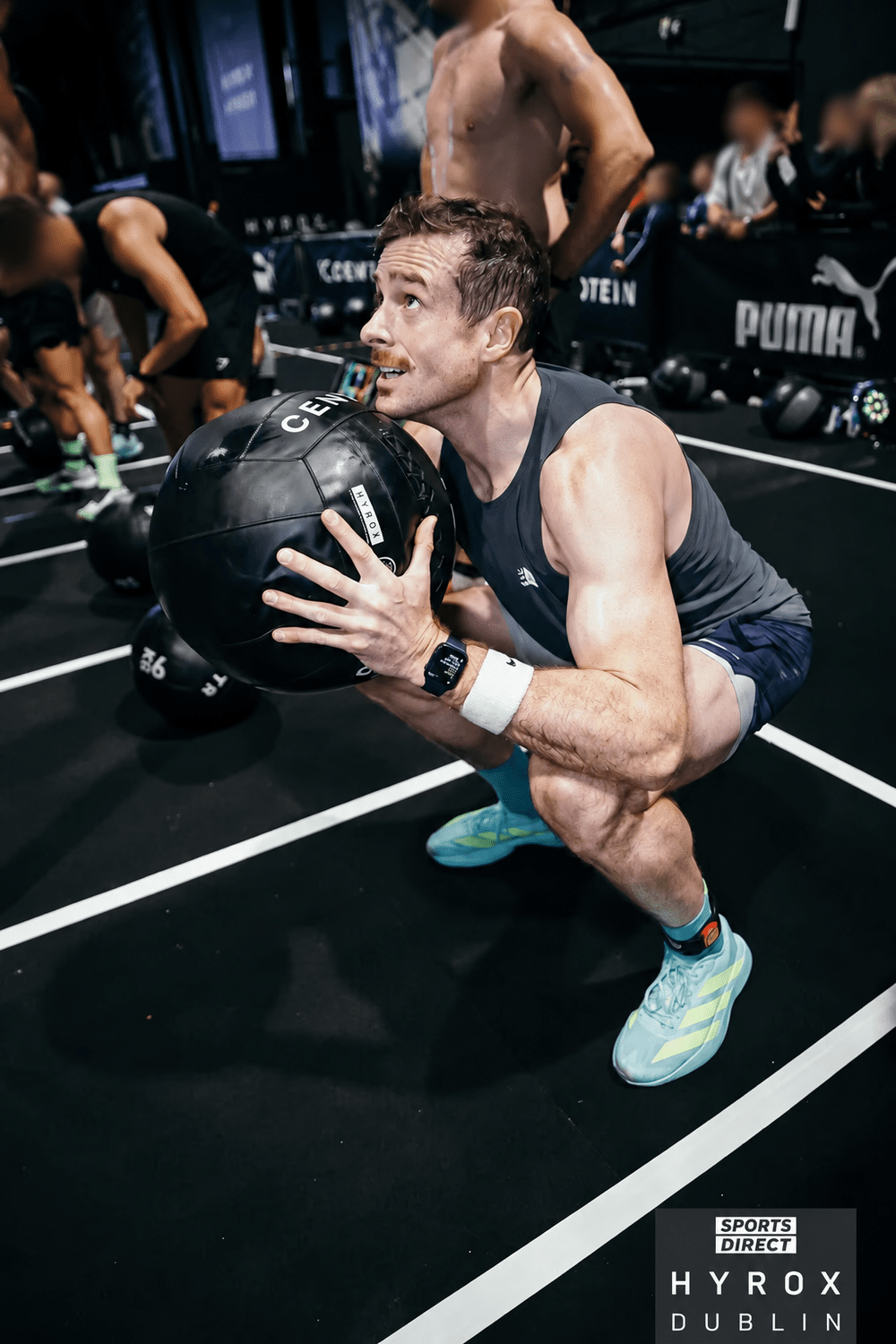 Kieran Lillis competing at HYROX Dublin, with other faces blurred for privacy.