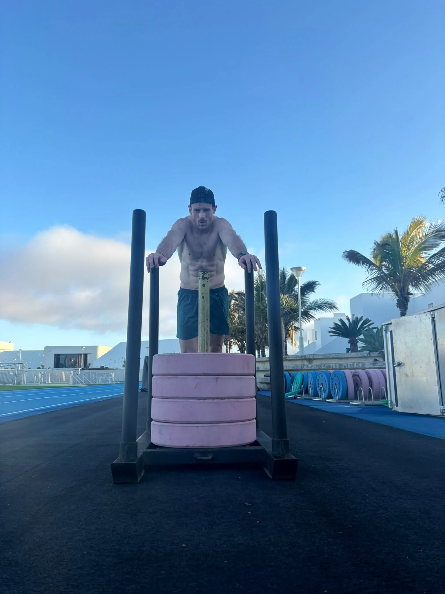 Kieran Lillis pushing a weighted sled during an outdoor training session in Portugal.