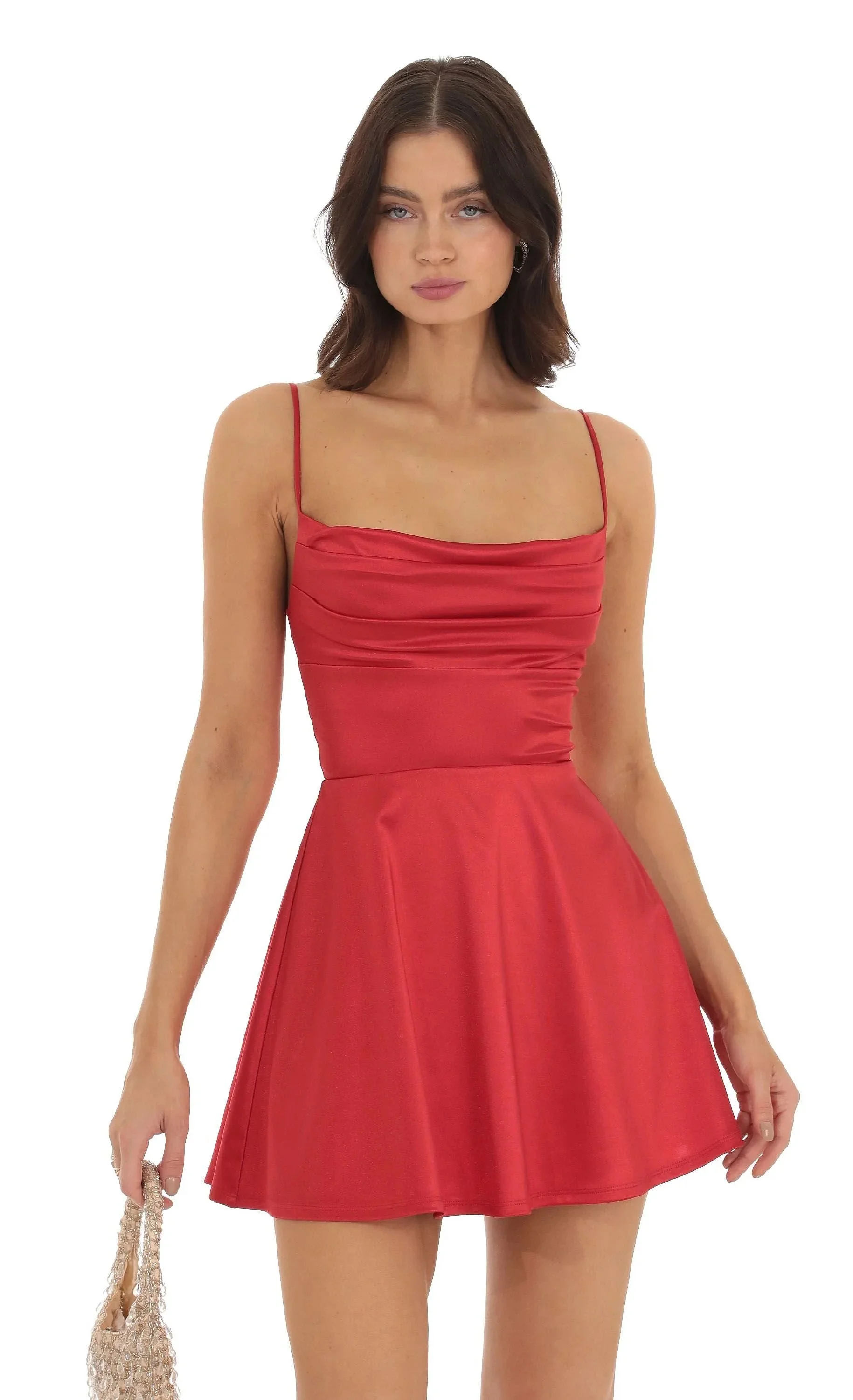 Close-up of red satin mini dress highlighting the draped cowl neckline and silky fabric that adds a luxurious touch to any look.