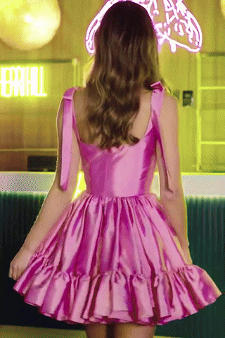 Animated GIF of a Sherri Hill pink satin short dress featuring bow straps, a fitted bodice, and flared skirt with ruffle hemline.