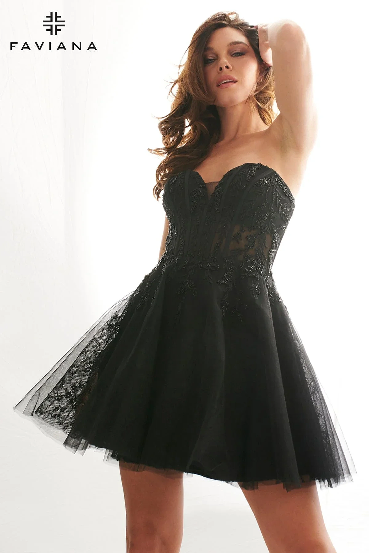 Close-up of strapless black Faviana homecoming dress with sheer lace bodice and sweetheart neckline.