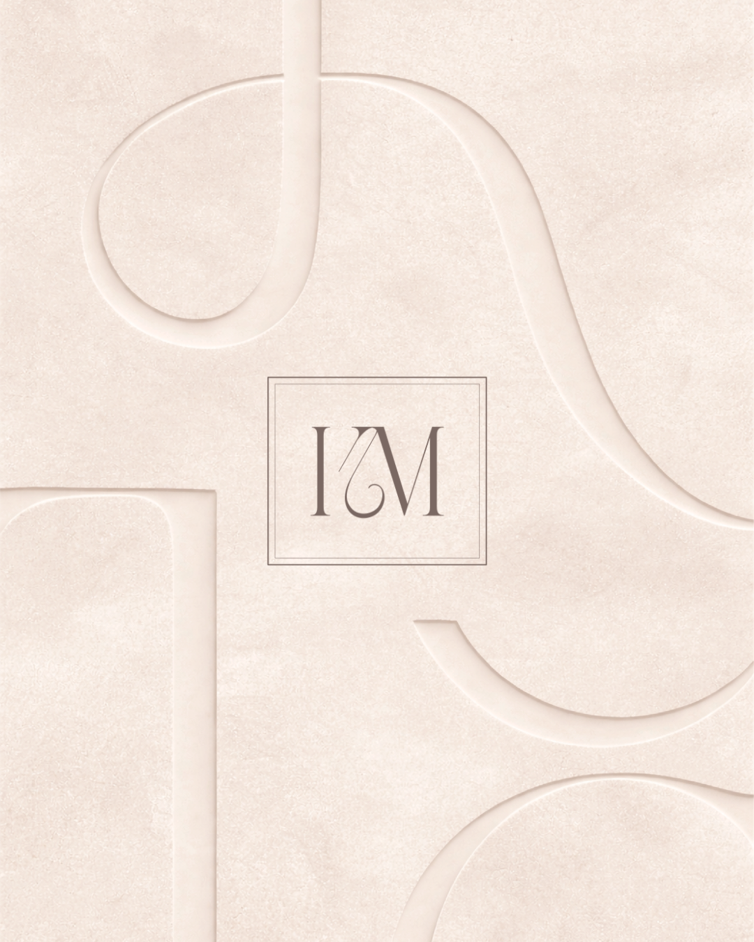 Close-up of a soft beige textured surface with a raised pattern and a square with the initials 'IM' in the center.