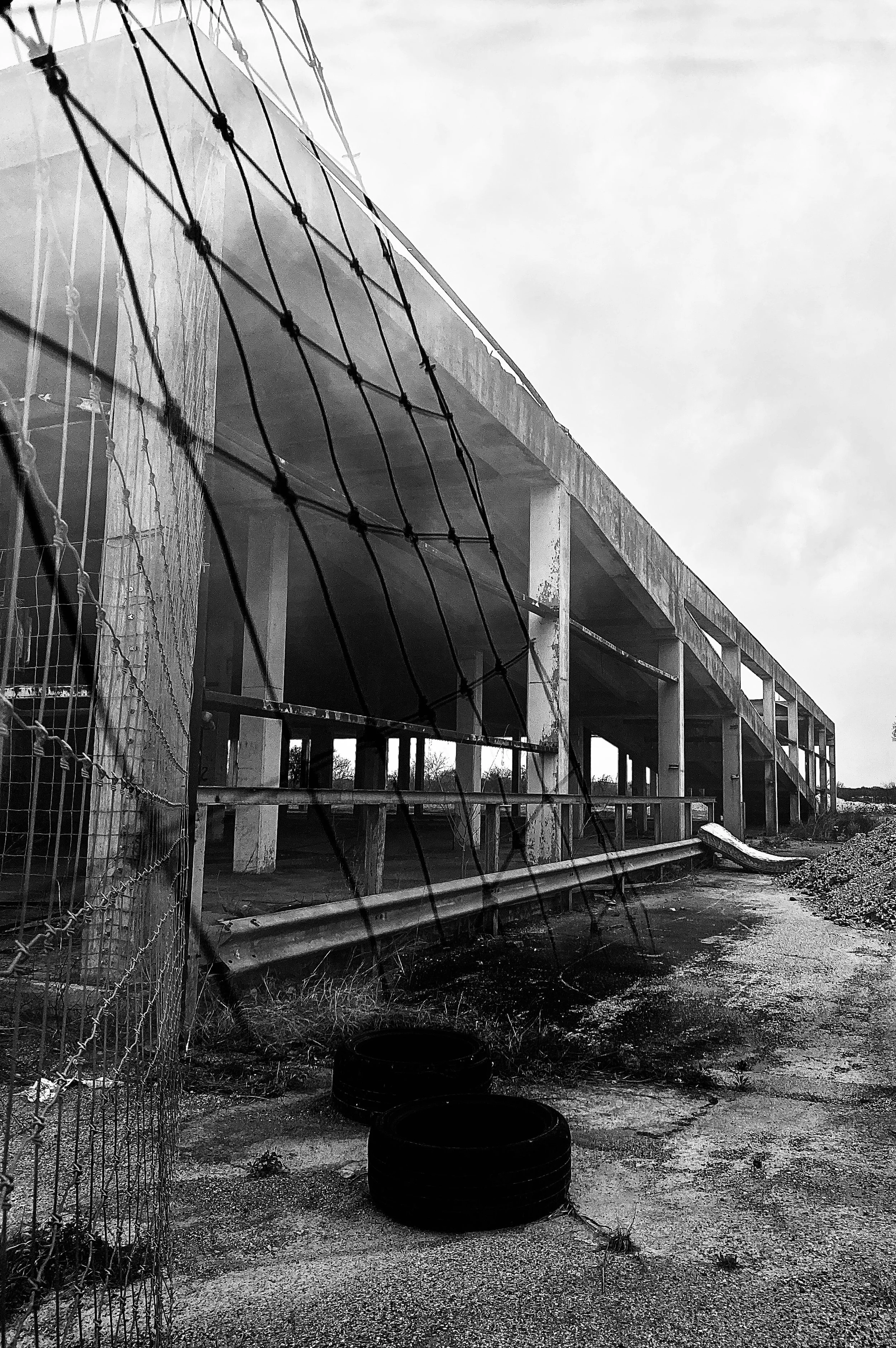 abandoned garage photographed through a piece of broken glass, reflecting the fencing surrounding the building