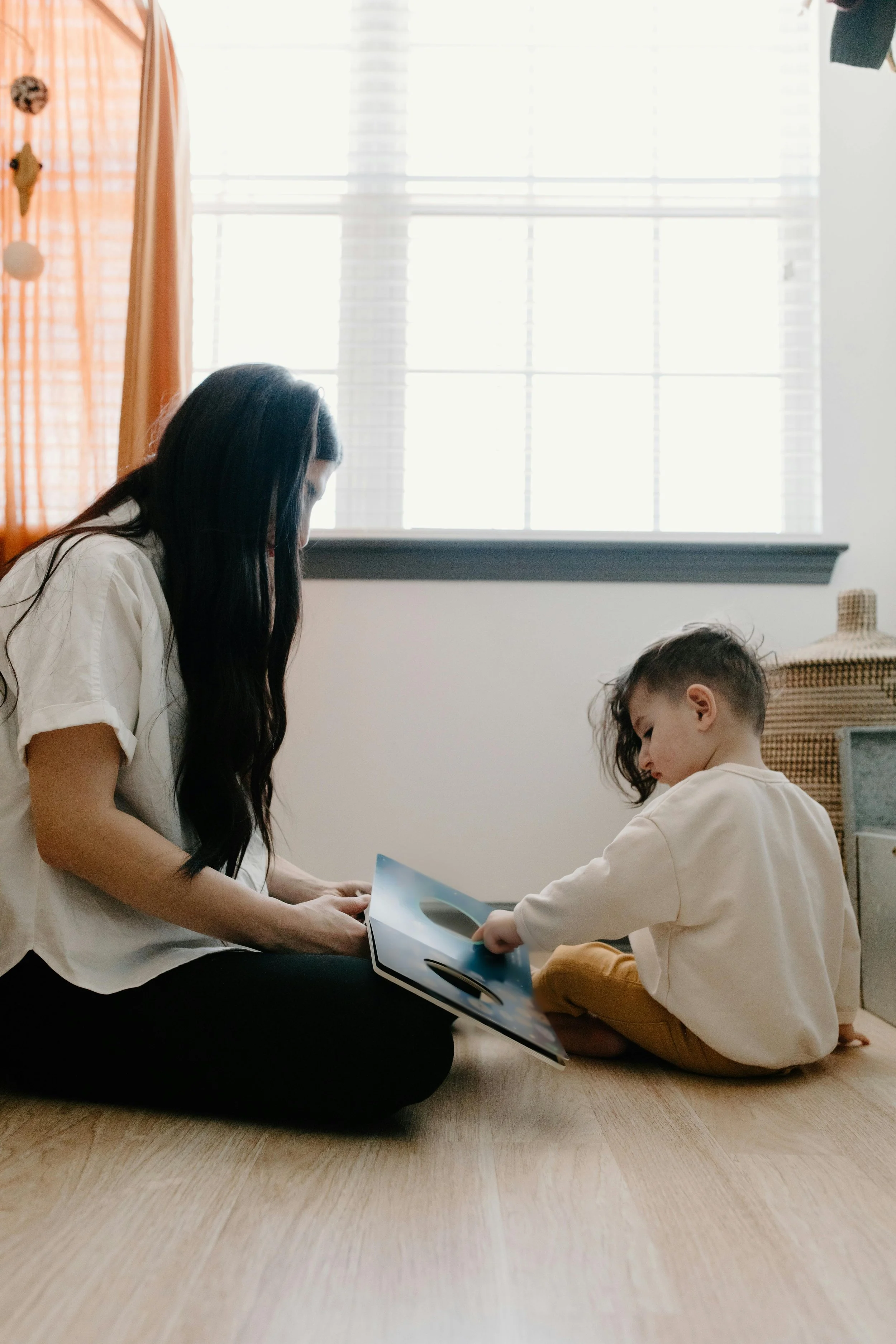 A Mother watching her child reading their book
