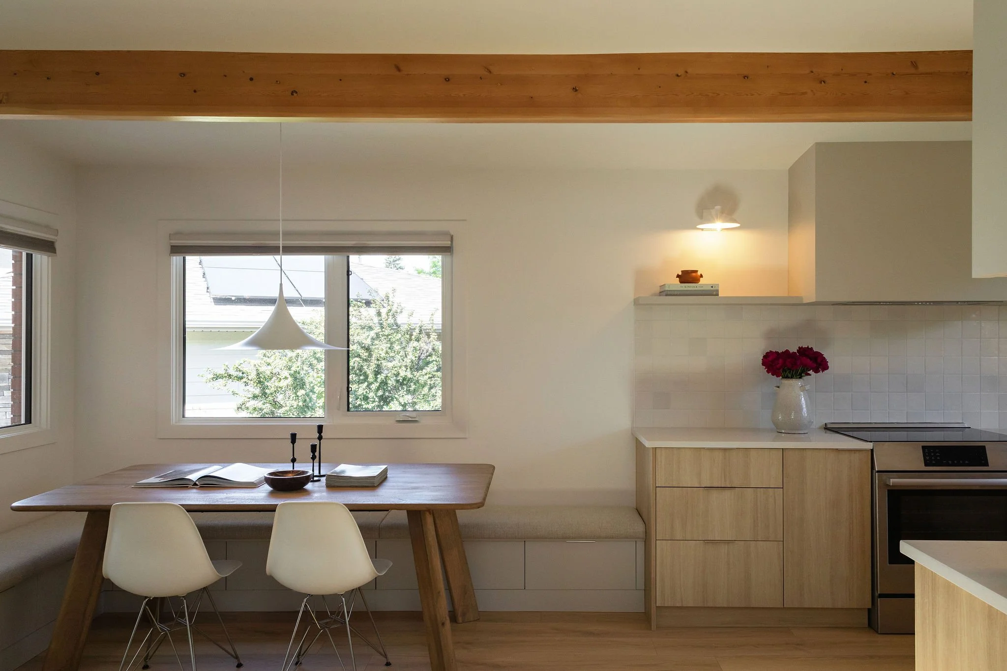 Bright dining room with statement lighting and natural wood accents.