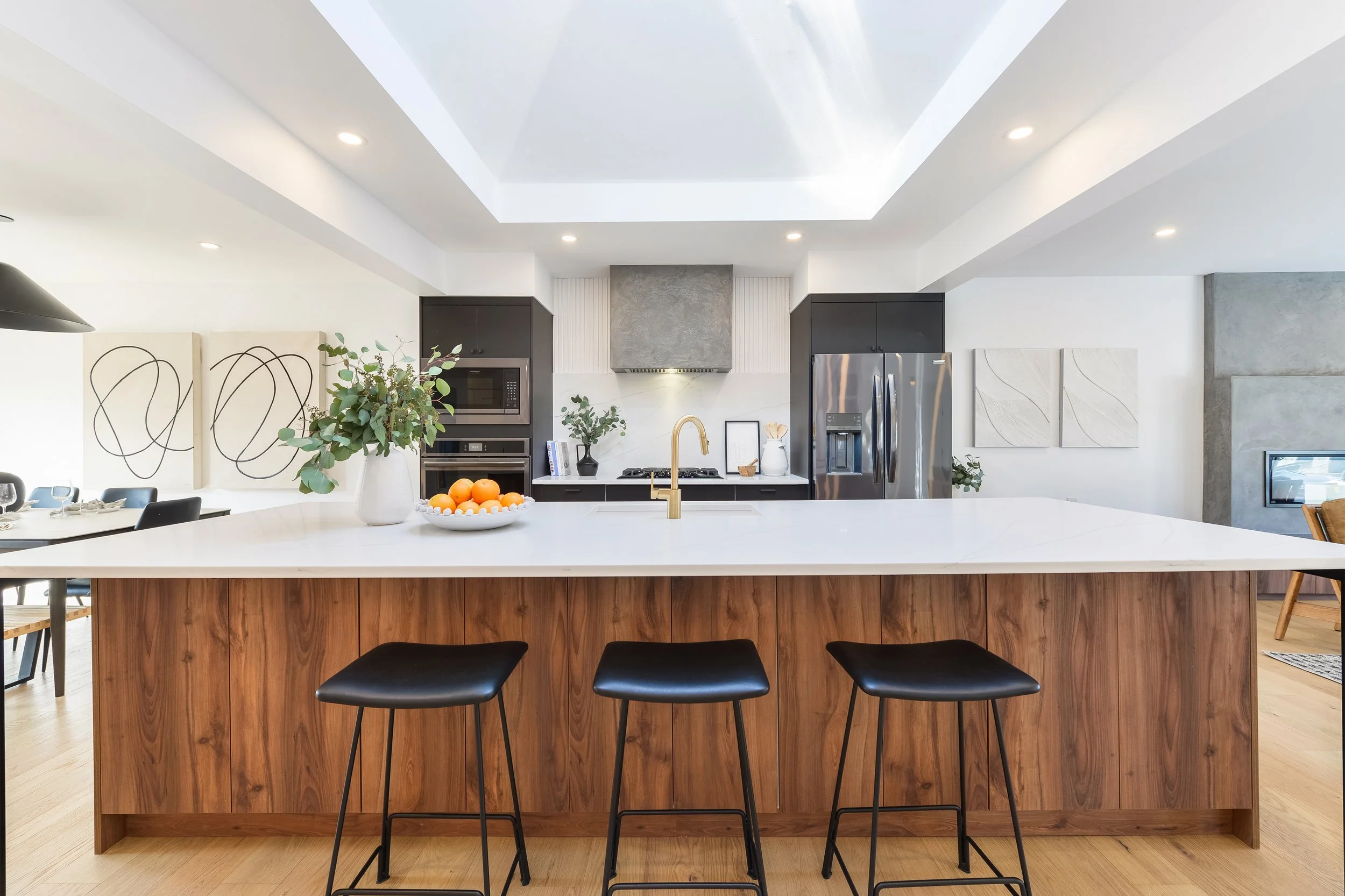 walnut and black kitchen with large skylight and oak floors