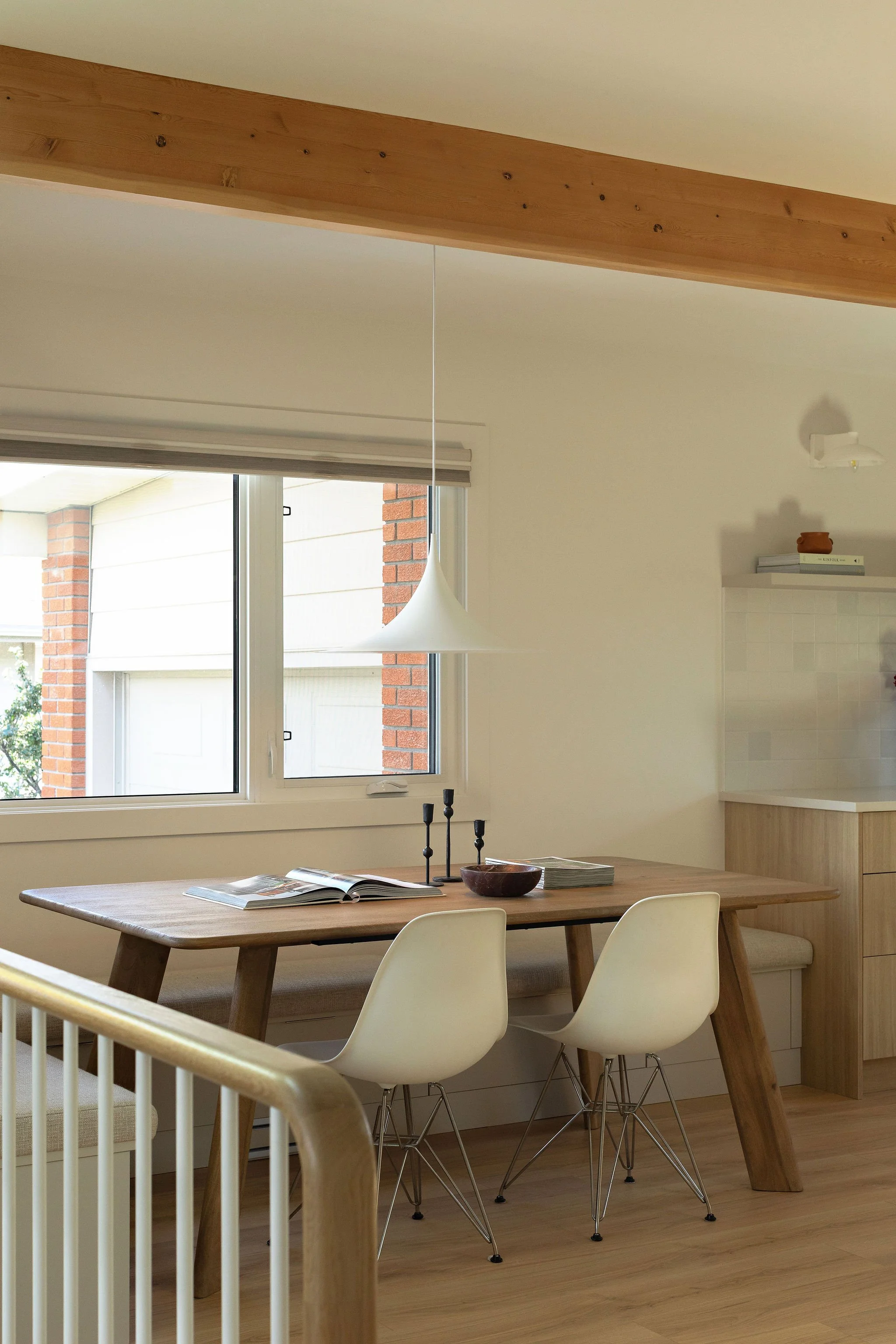 Open-concept dining area in a renovated mid-century bungalow.