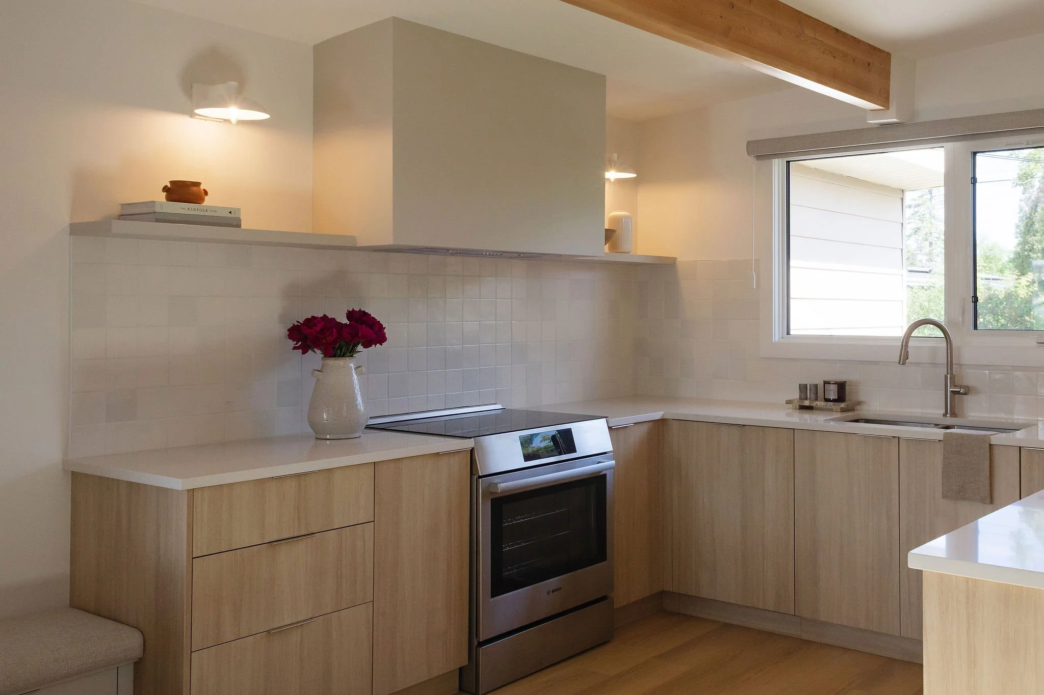 Scandinavian kitchen renovation with custom white oak cabinetry and quartz countertops.