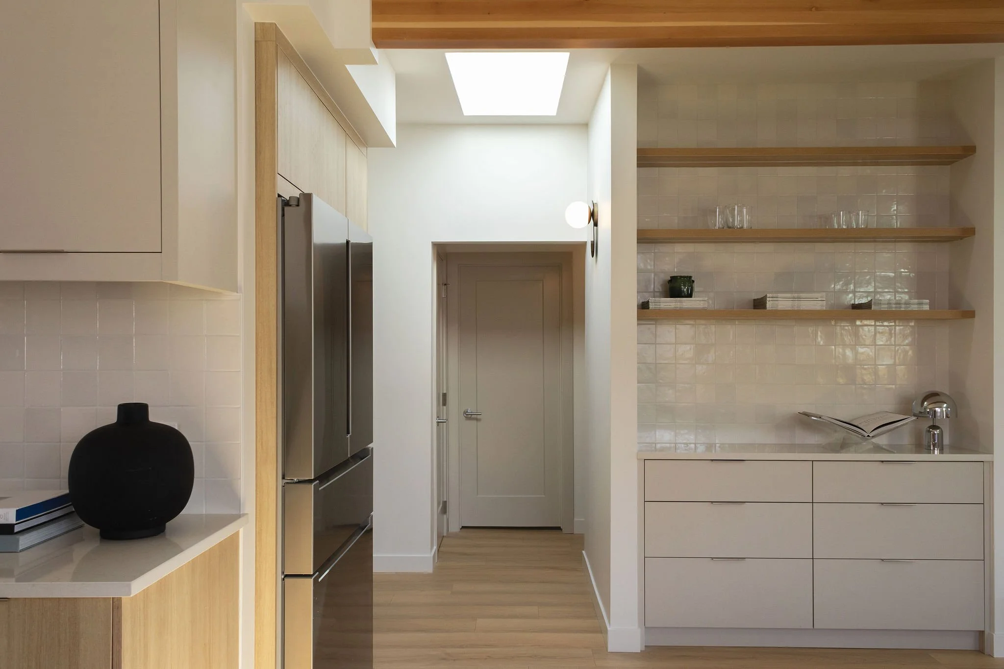 Custom breakfast bar with white oak cabinetry and quartz countertops.