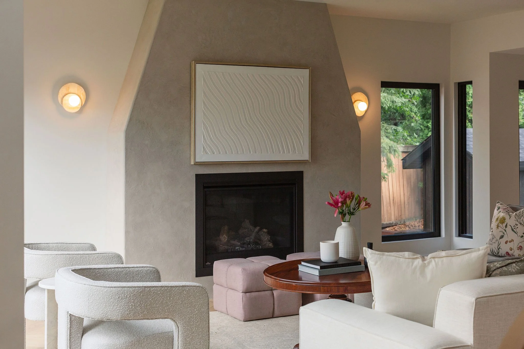 living room with big windows and limewash gas fireplace., neutral furniture and herringbone wood floors