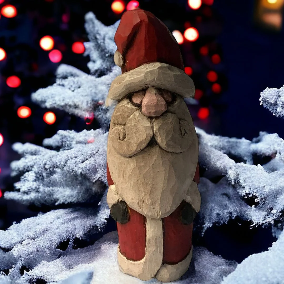 Wooden Santa Claus figurine with a red hat and coat placed on snow-covered pine branches, with blurred red and orange Christmas lights in the background.