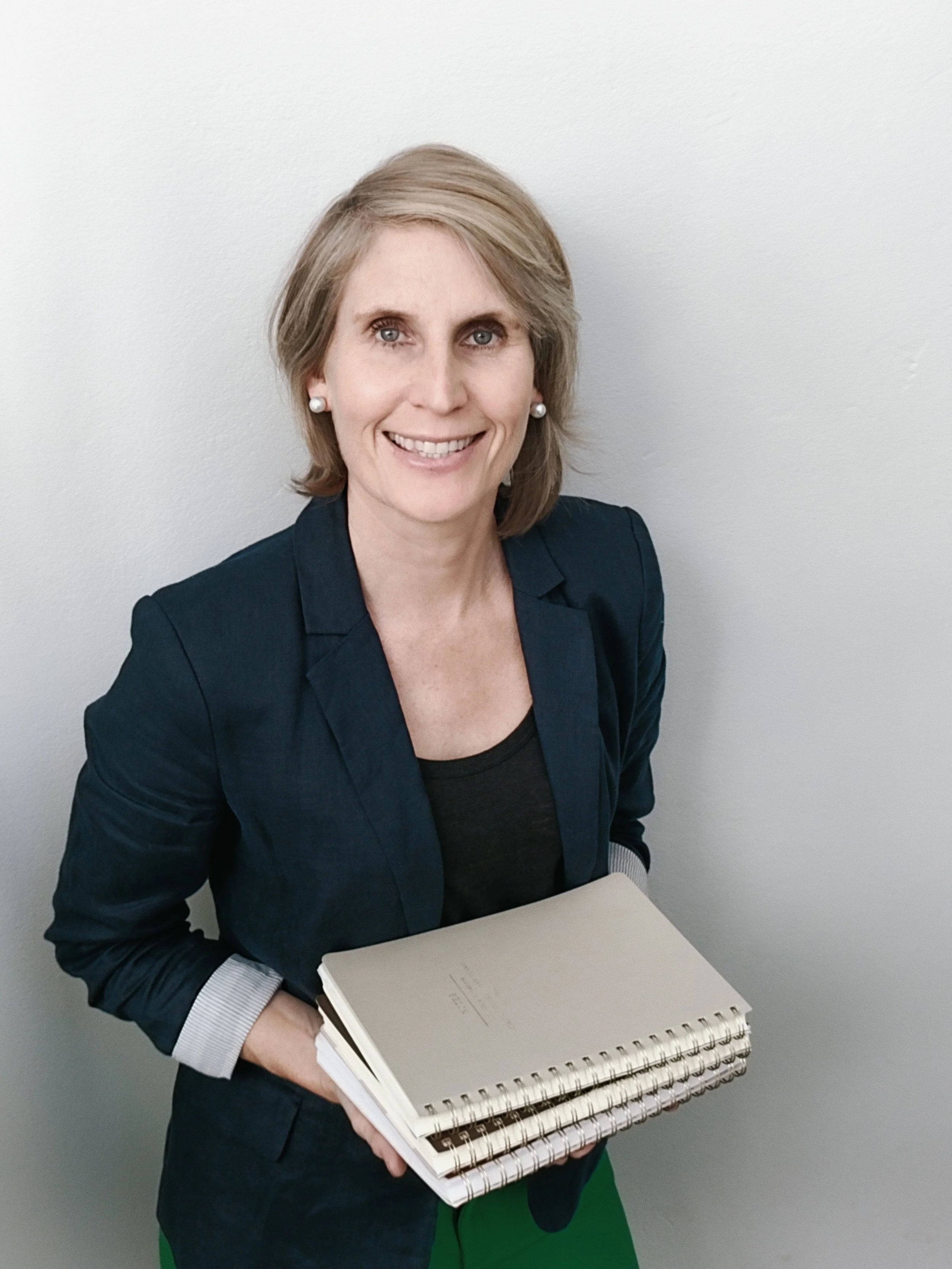 Nikki holding workshop resources from mentoring sessions with educators