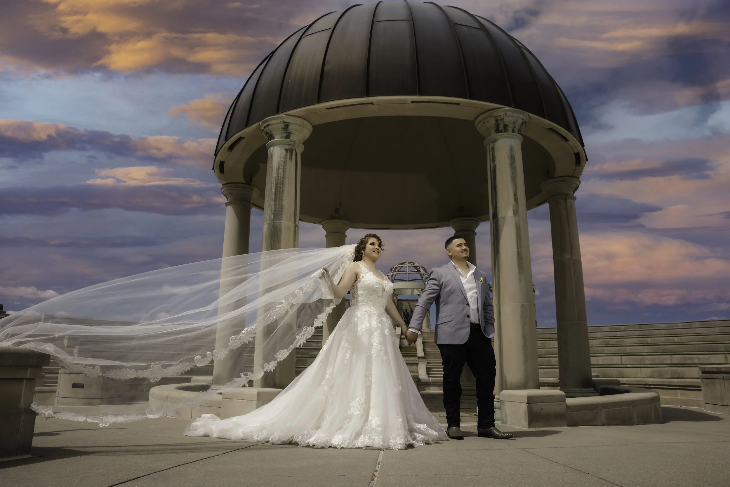 Bride and groom holding hands under gazebo at sunset – wedding photography and video coverage by Eli Mestas Indianapolis