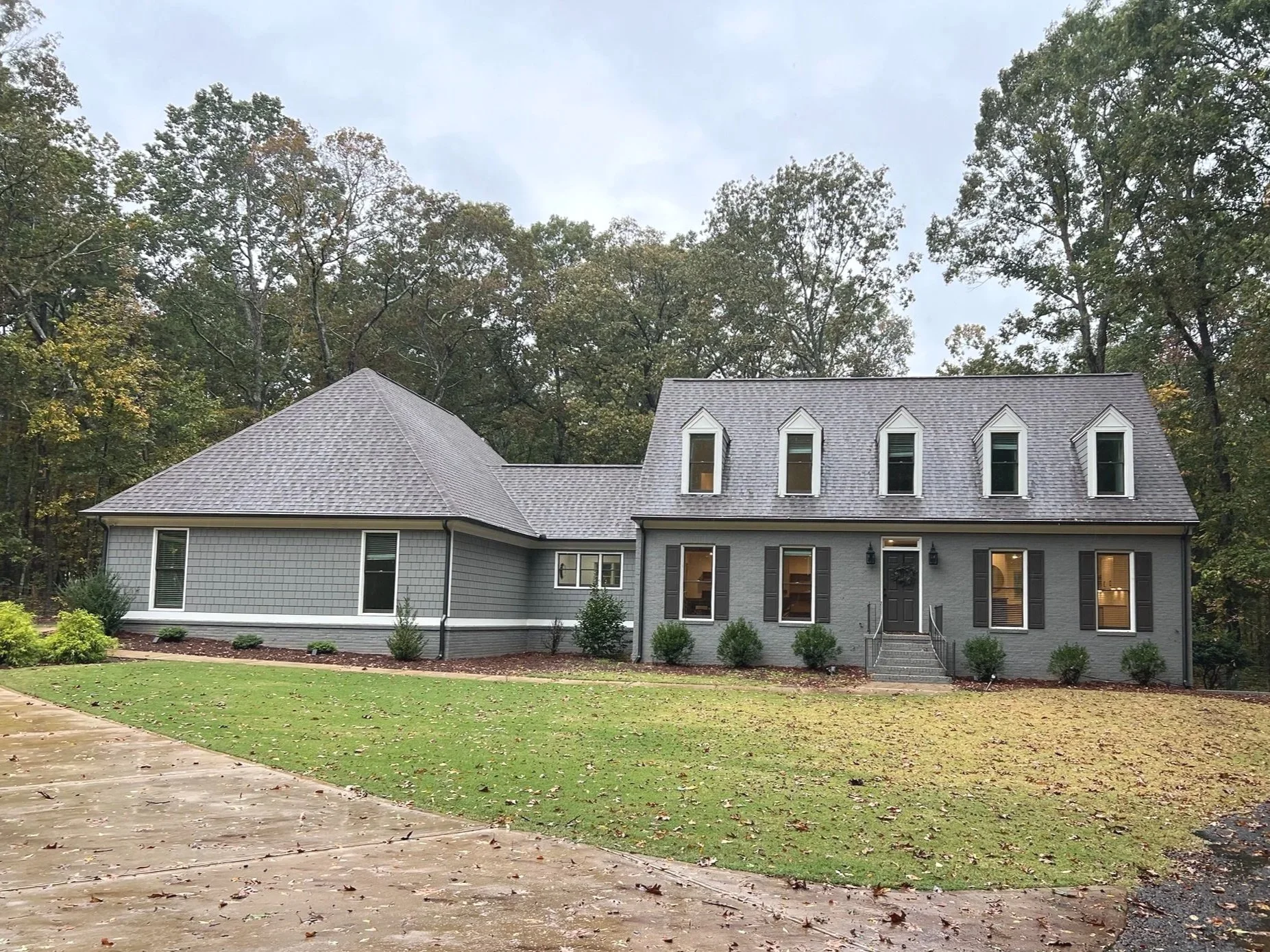 Updated front elevation with addition featuring 2-car garage, oversized master suite and bathroom, and mud room/laundry