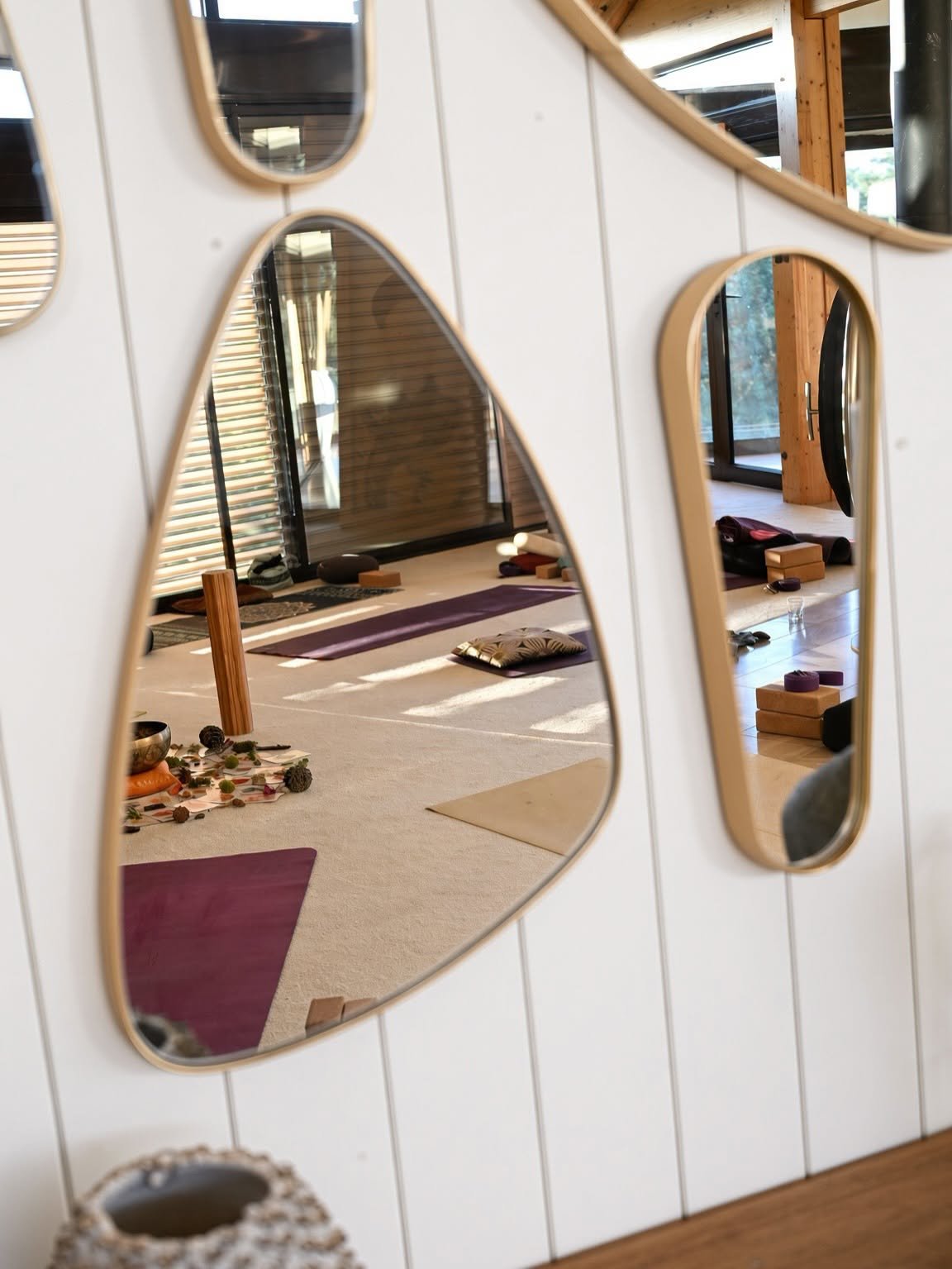 Salle de yoga lumineuse aux miroirs de forme organique