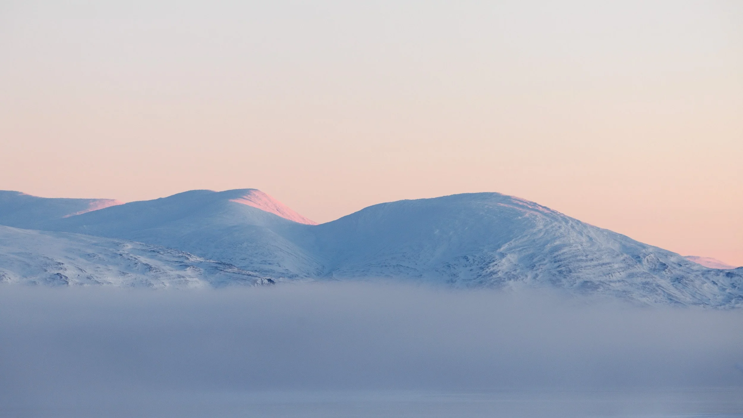 The first sun is hitting the mountains on the other side of laee tornetrask