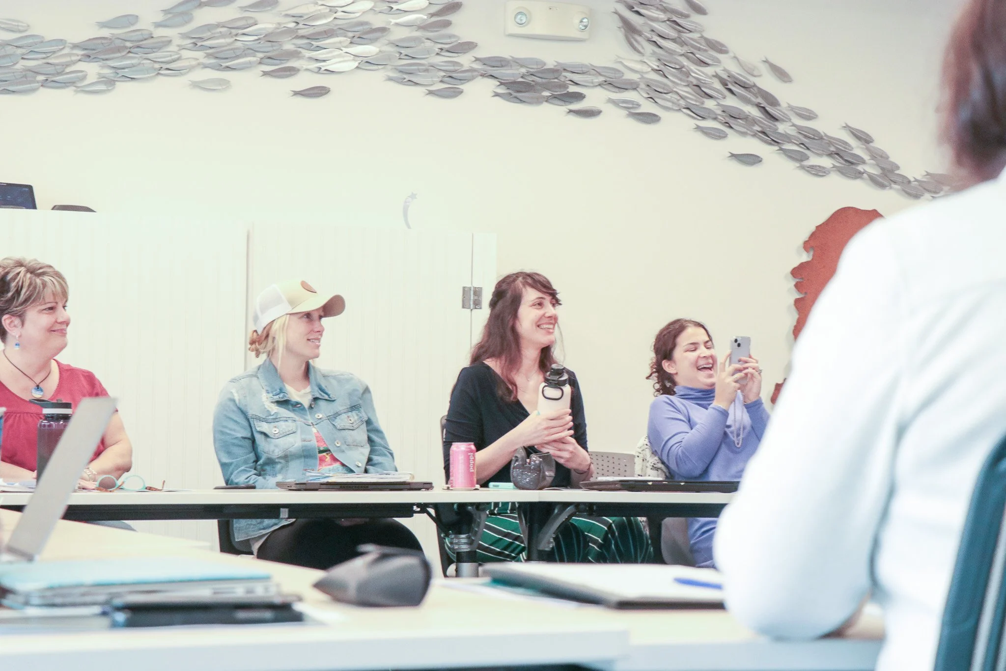 Small-business owners at a Boost Your Brand workshop, laughing and working through the session together