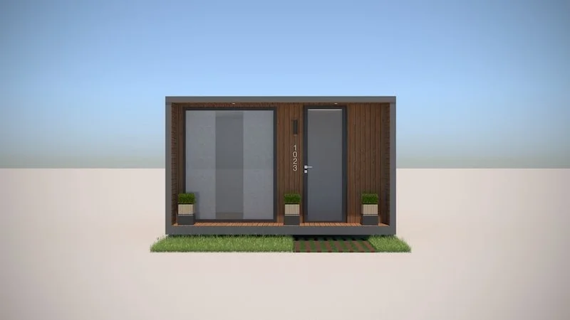 Modern tiny house with wooden exterior, large front window, door with house number 1023, and small front yard with grass and stepping stones.