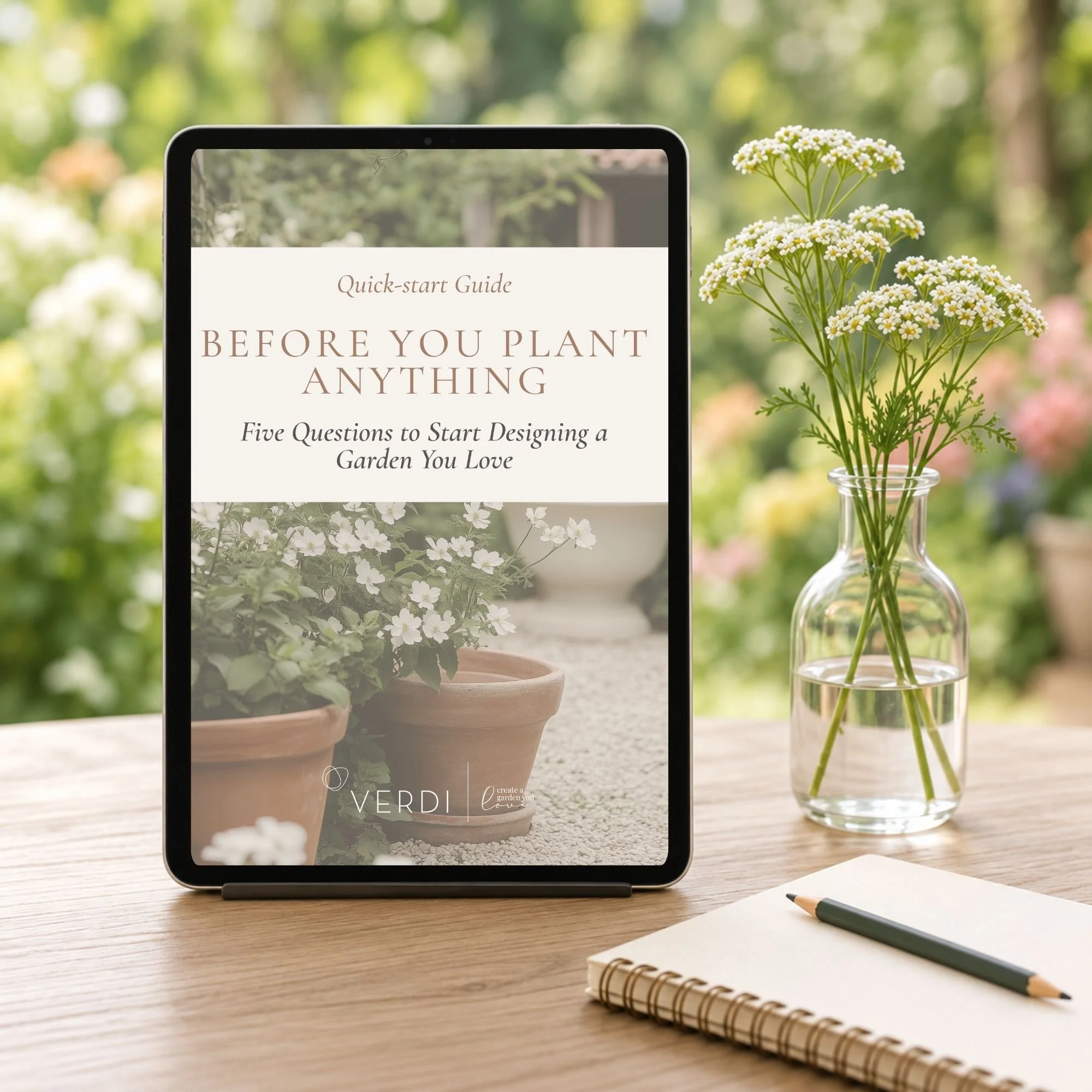 Before You Plant Anything garden-design Quick-Start Guide displayed on a tablet beside a notebook and flowers.
