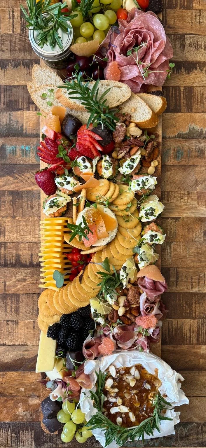 Luxury handcrafted charcuterie platter by Chef's  Platters featuring artisan cheeses, cured meats, fresh fruit and gourmet accompaniments.