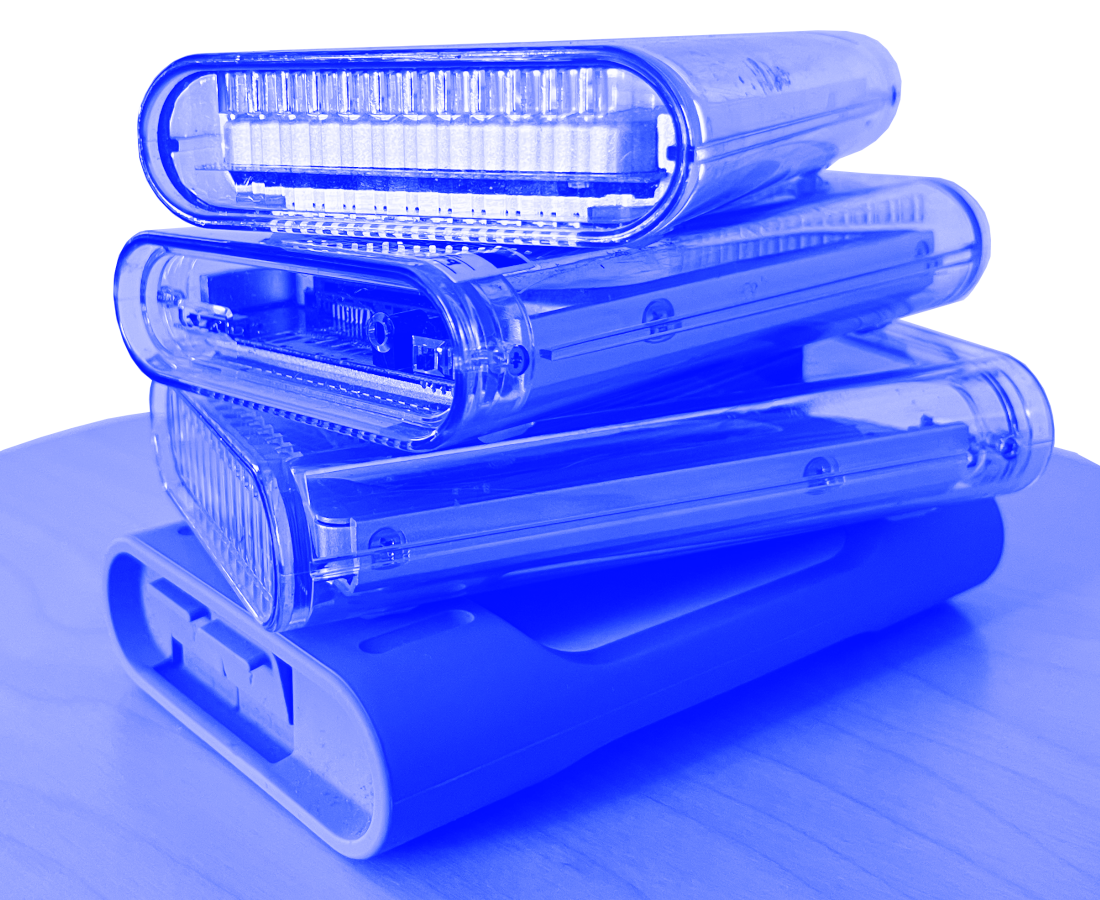 Close-up of multiple overlapping clear plastic tissue box holders in blue tint.