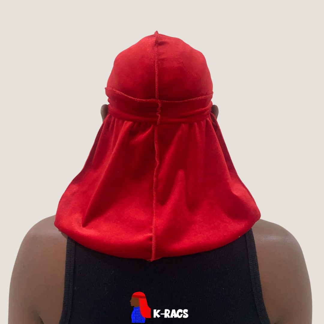 A person wearing a red durag and black tank top, viewed from behind, with a gray background.