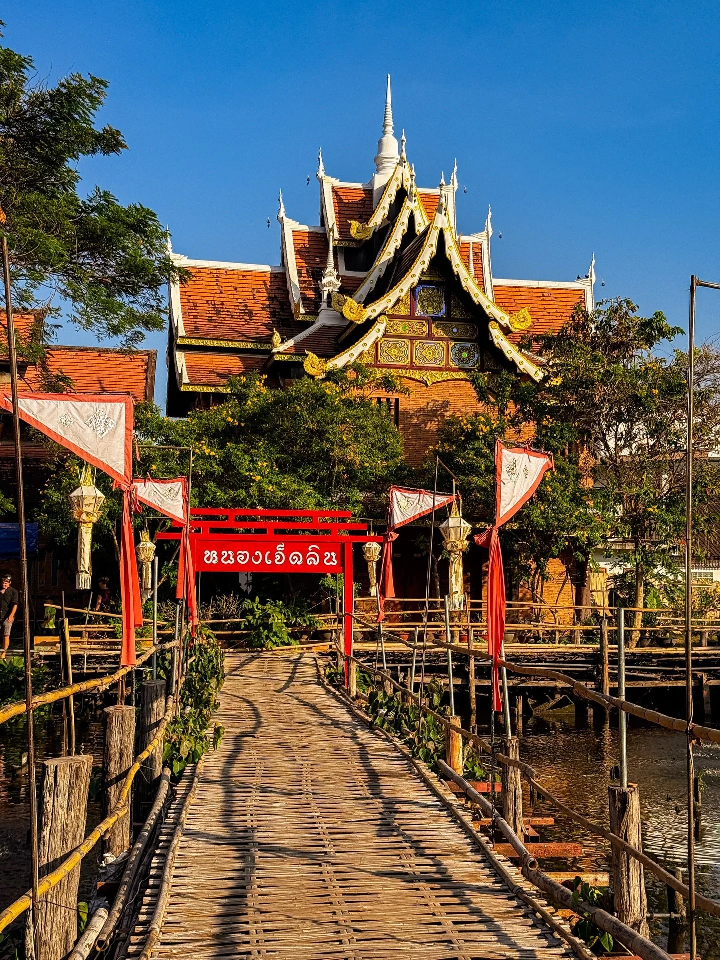 Like most of out temple visits, this one was unplanned. We wandered into Wat Chen Lin and were surprised to find it built around the water with bamboo bridges and places to buy fish food for the swimming gangs for catfish. We fed the fish, snapped so