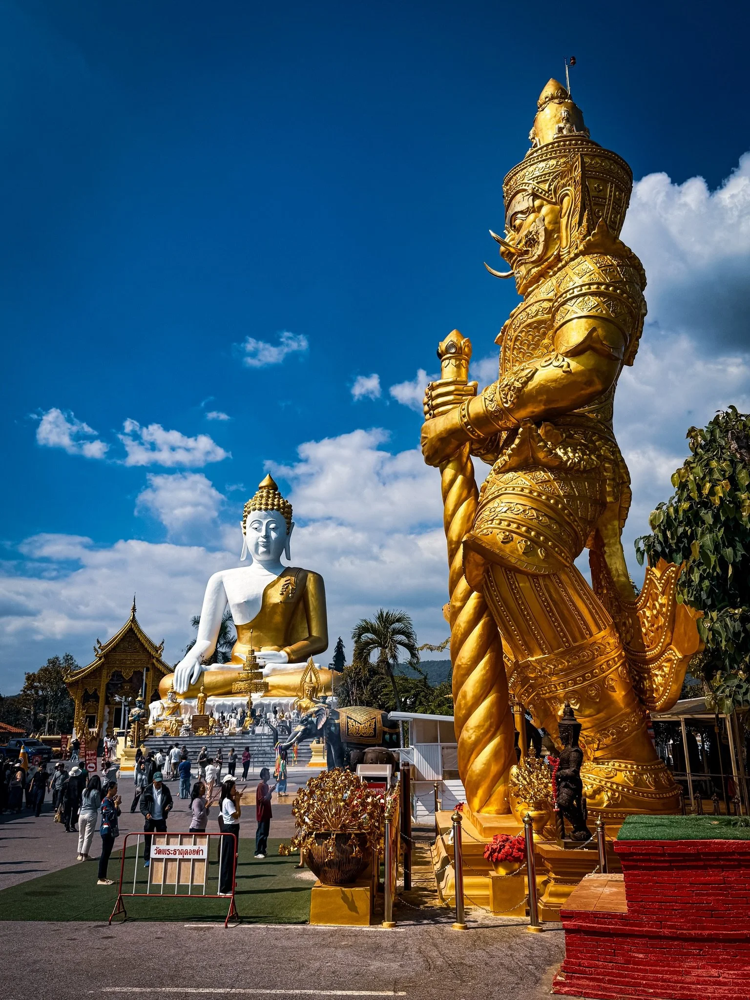 First stop on our Chiang Mai temple day tour. Wat Phra That Doi Kham overlooking the city. It was really hot out and we were glad to be arriving in an air conditioned car and not be hiking up the stairs in the heat. The statues are so big that you ca
