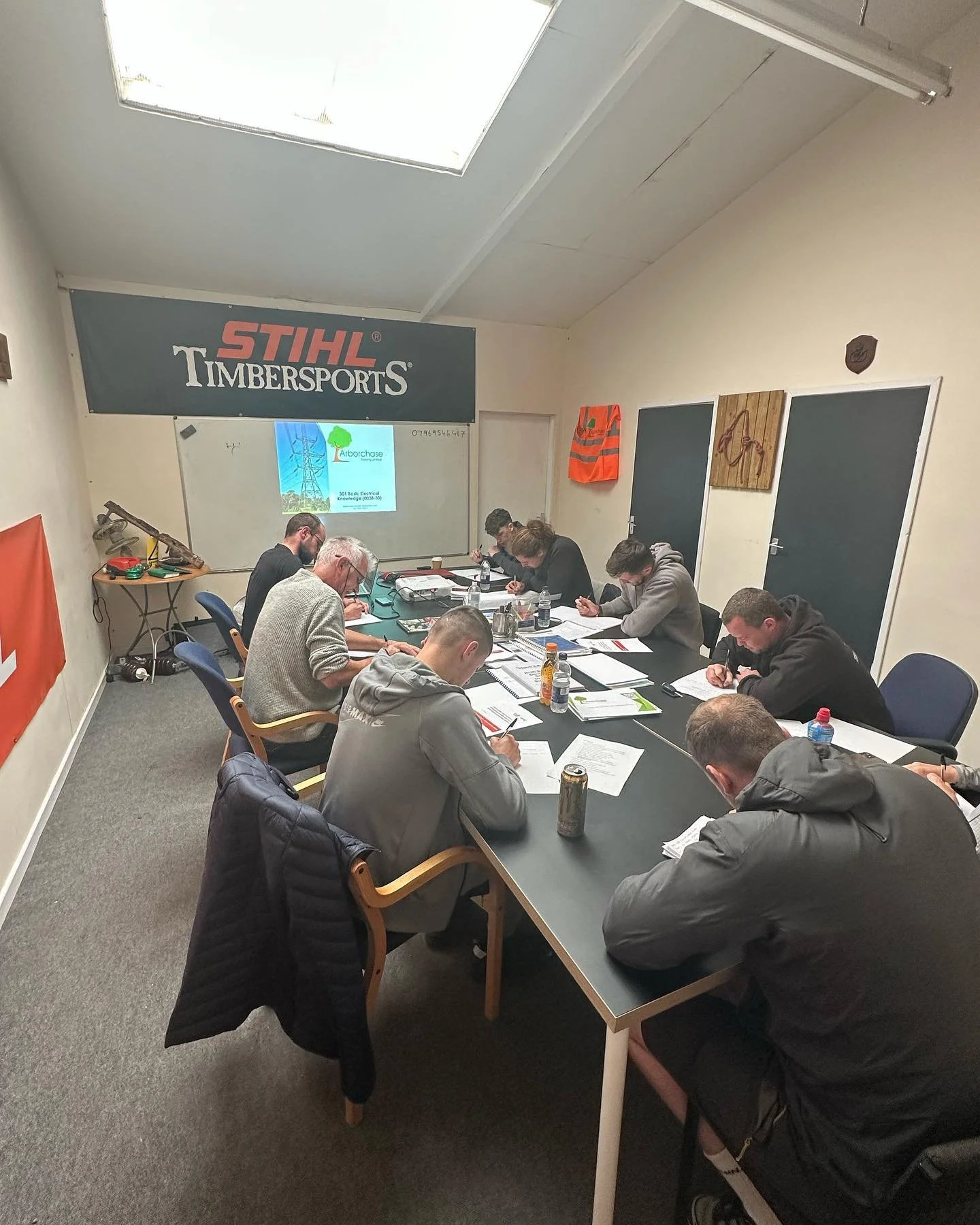 People sitting around a table writing on paper.